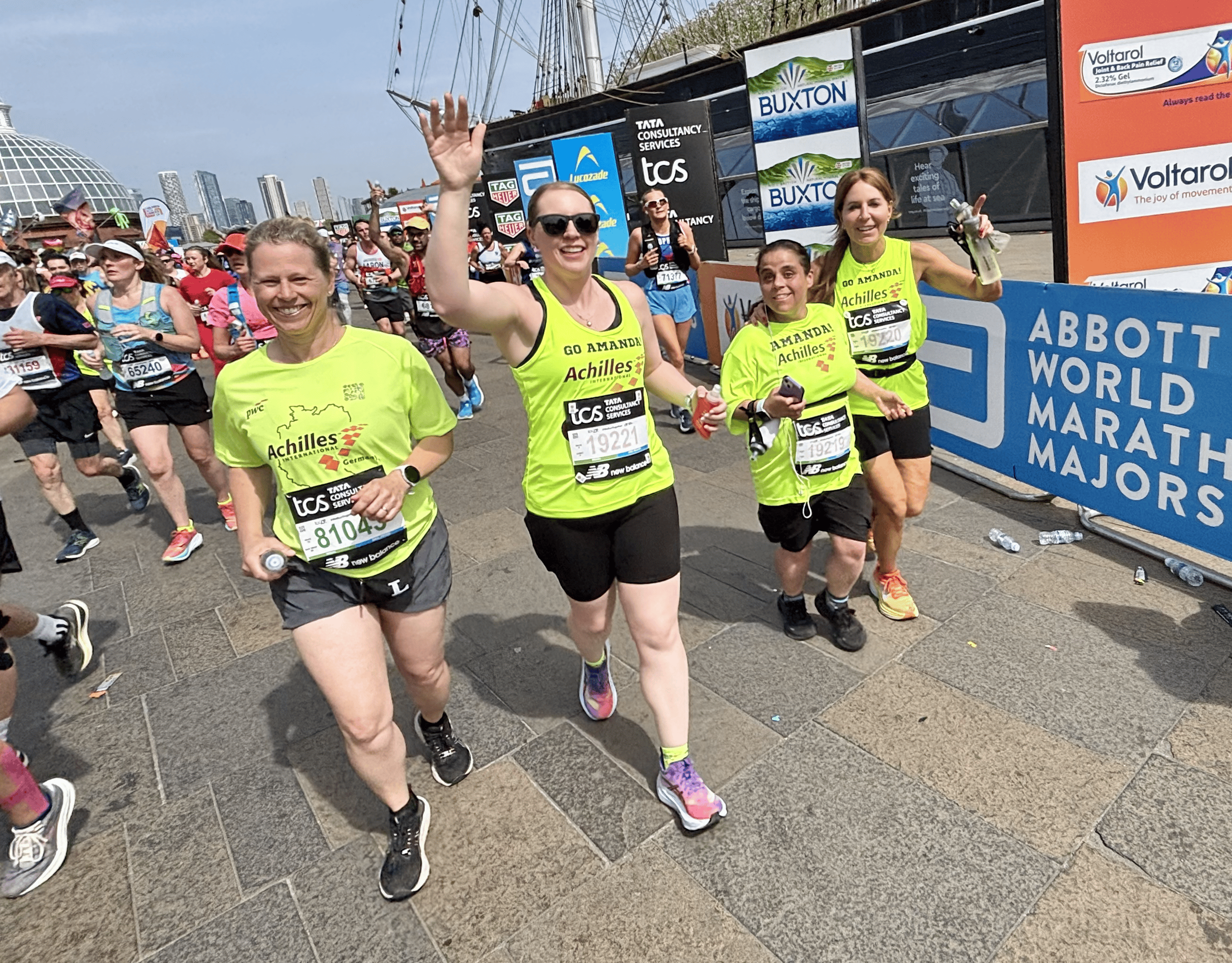  Achilles athlete running alongside her guides on the London Marathon race course.  