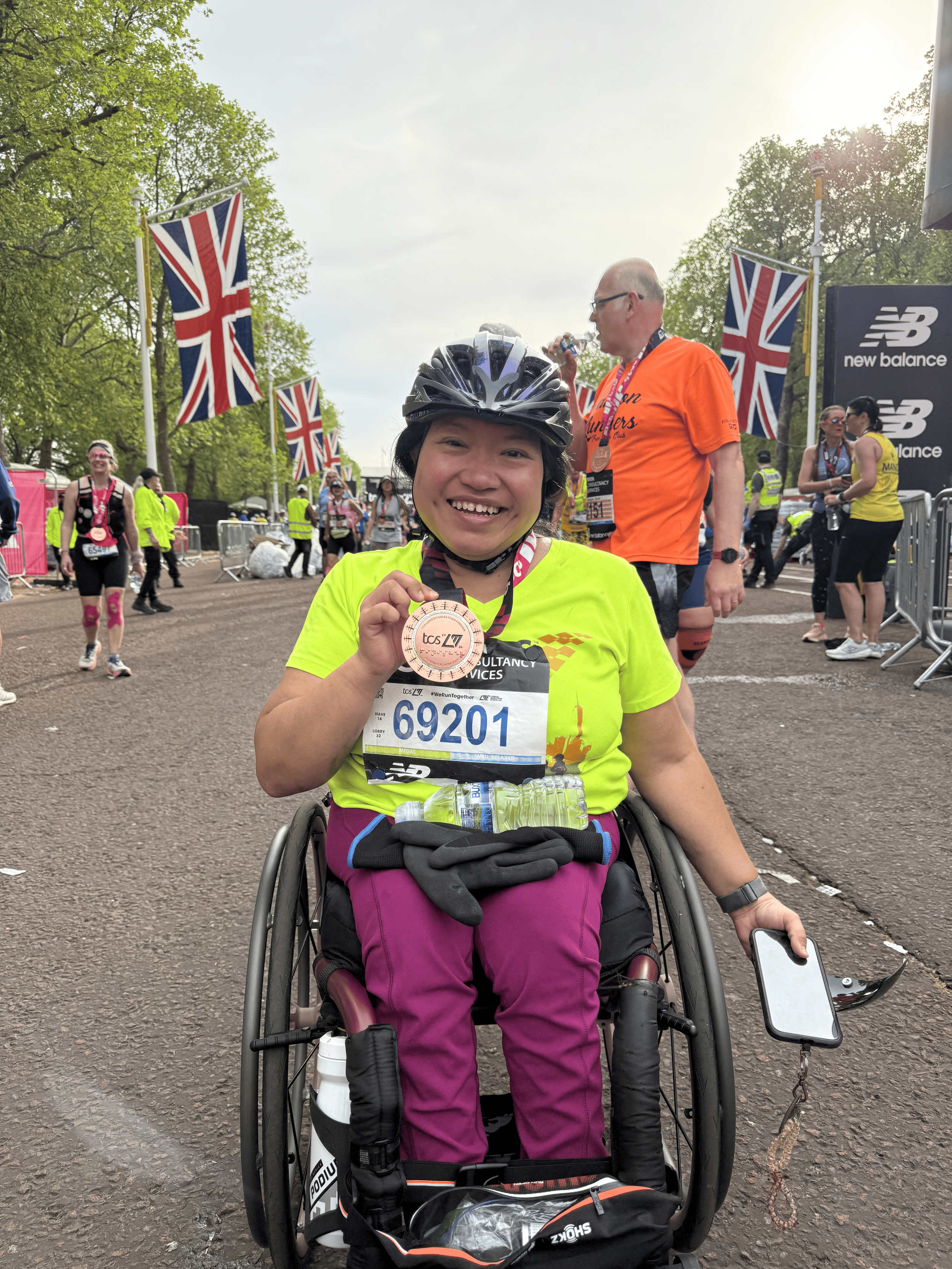  Achilles athlete posing with her London Marathon medal.  