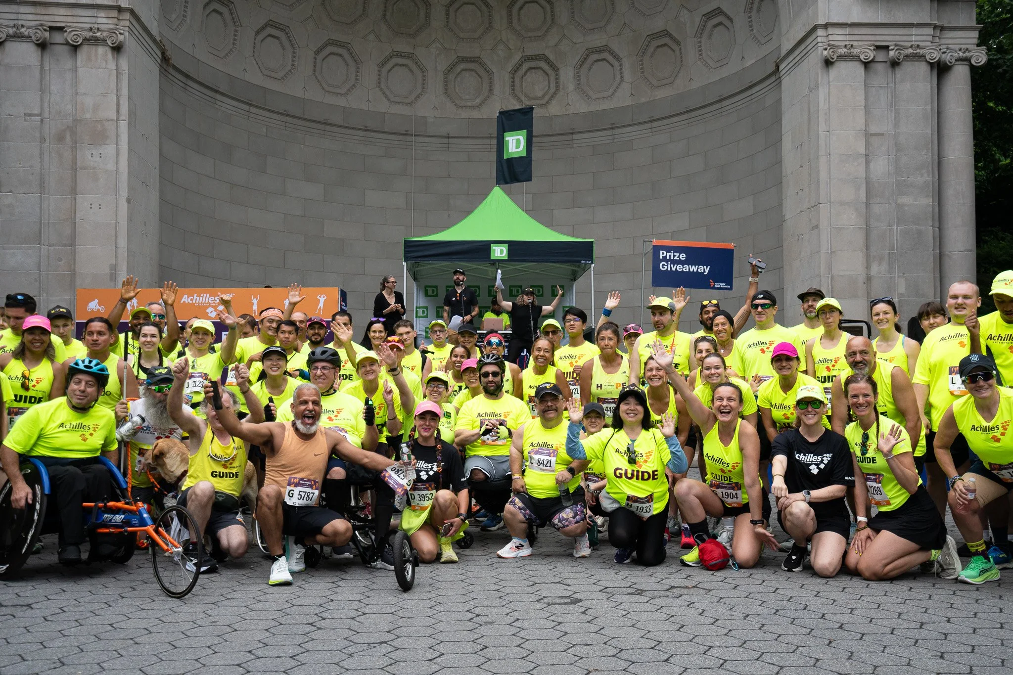  Group shot of athletes and guides cheering together in the festival area.  