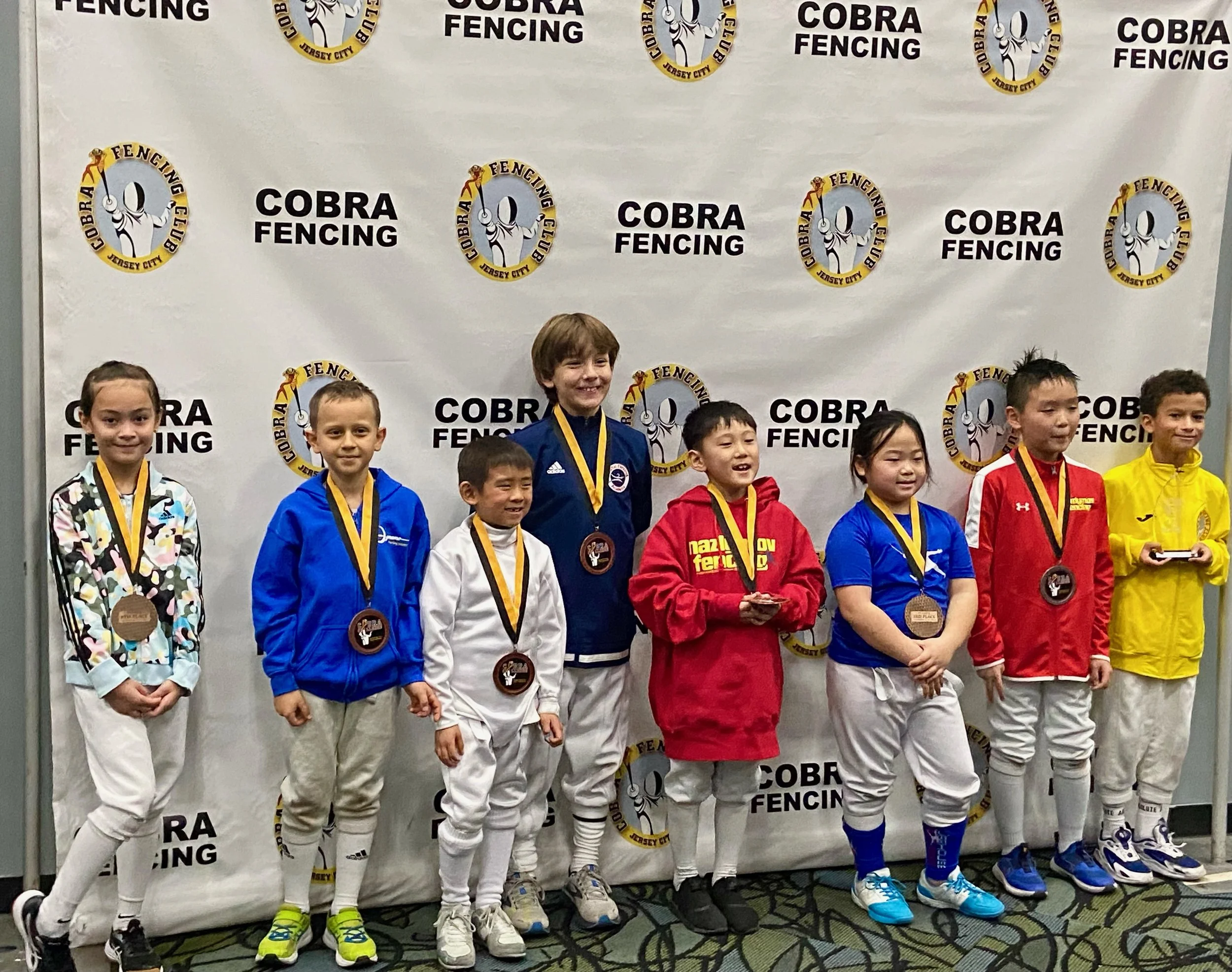Jordanna Daniels with her 8th Place Medal in Y8 Mixed Saber at the Cobra Challenge