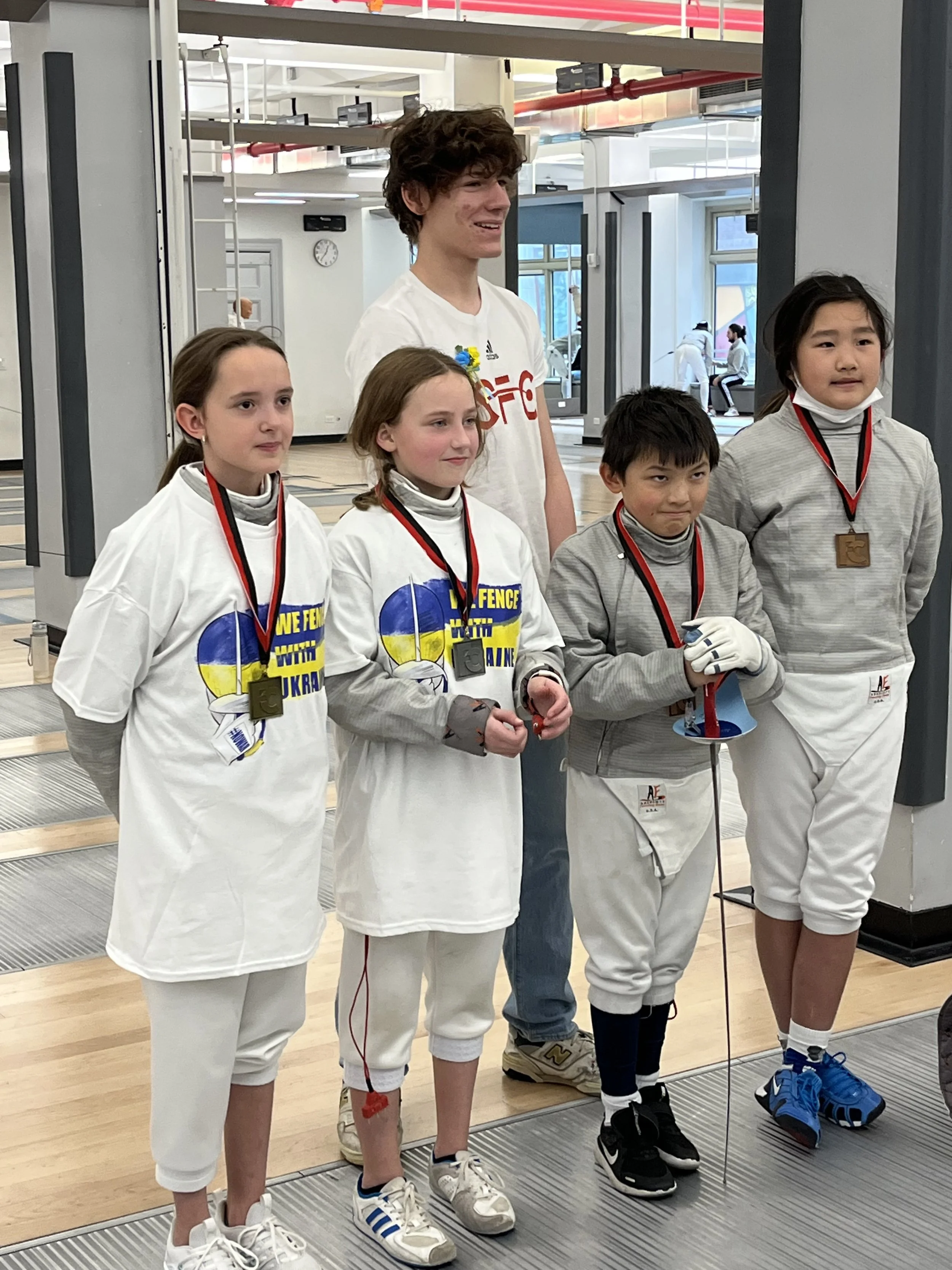 Olivia Pienkowski, Leah Lochridge, and Chloe Wang with Gold, Silver, and Bronze Medals at the Fencer's Club Youth Cup