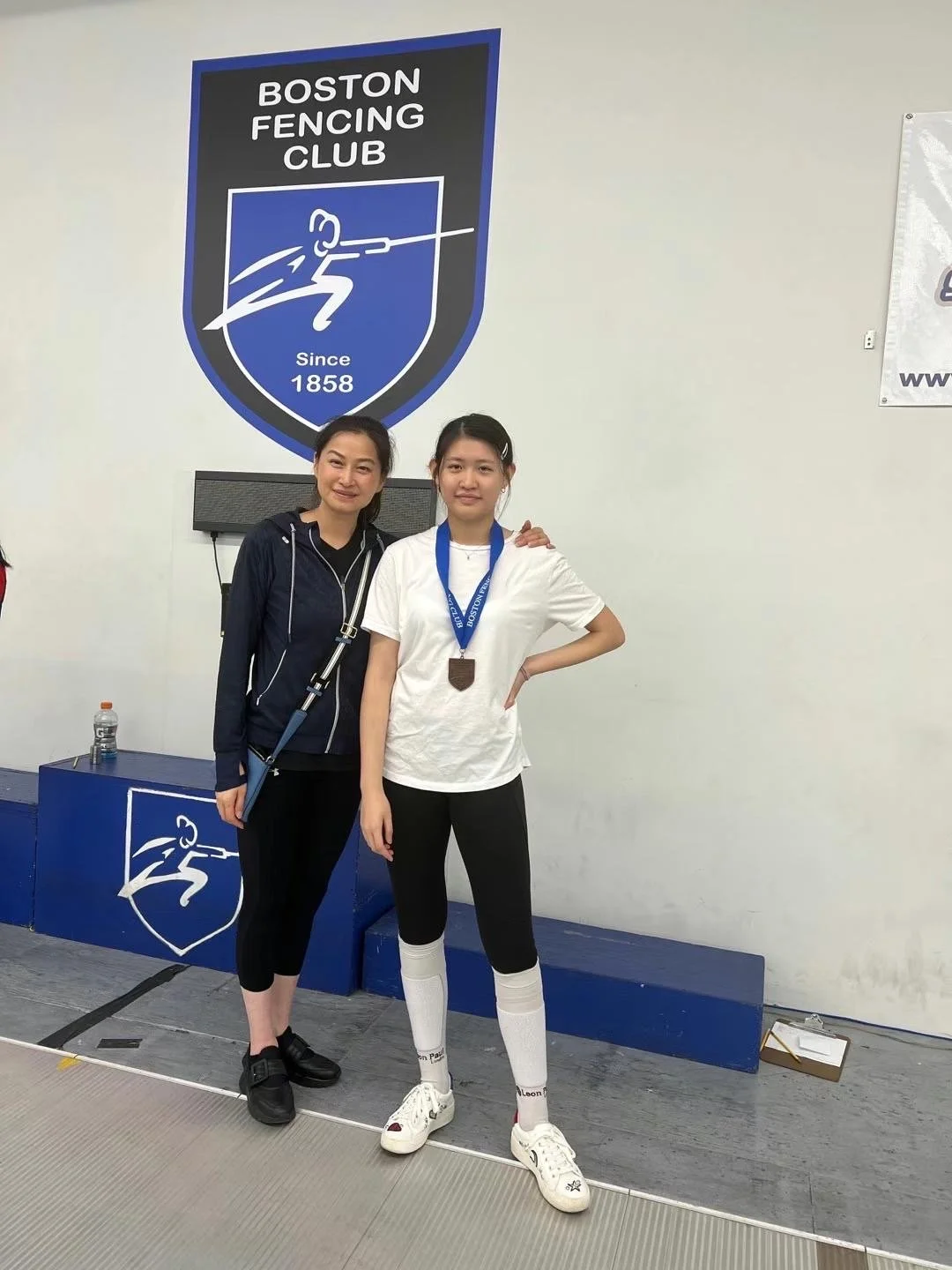 Catherine Chen and Coach Bao at the Boston Fencing Club RJCC, following Catherine's Gold Medal finish and earning her A22 rating
