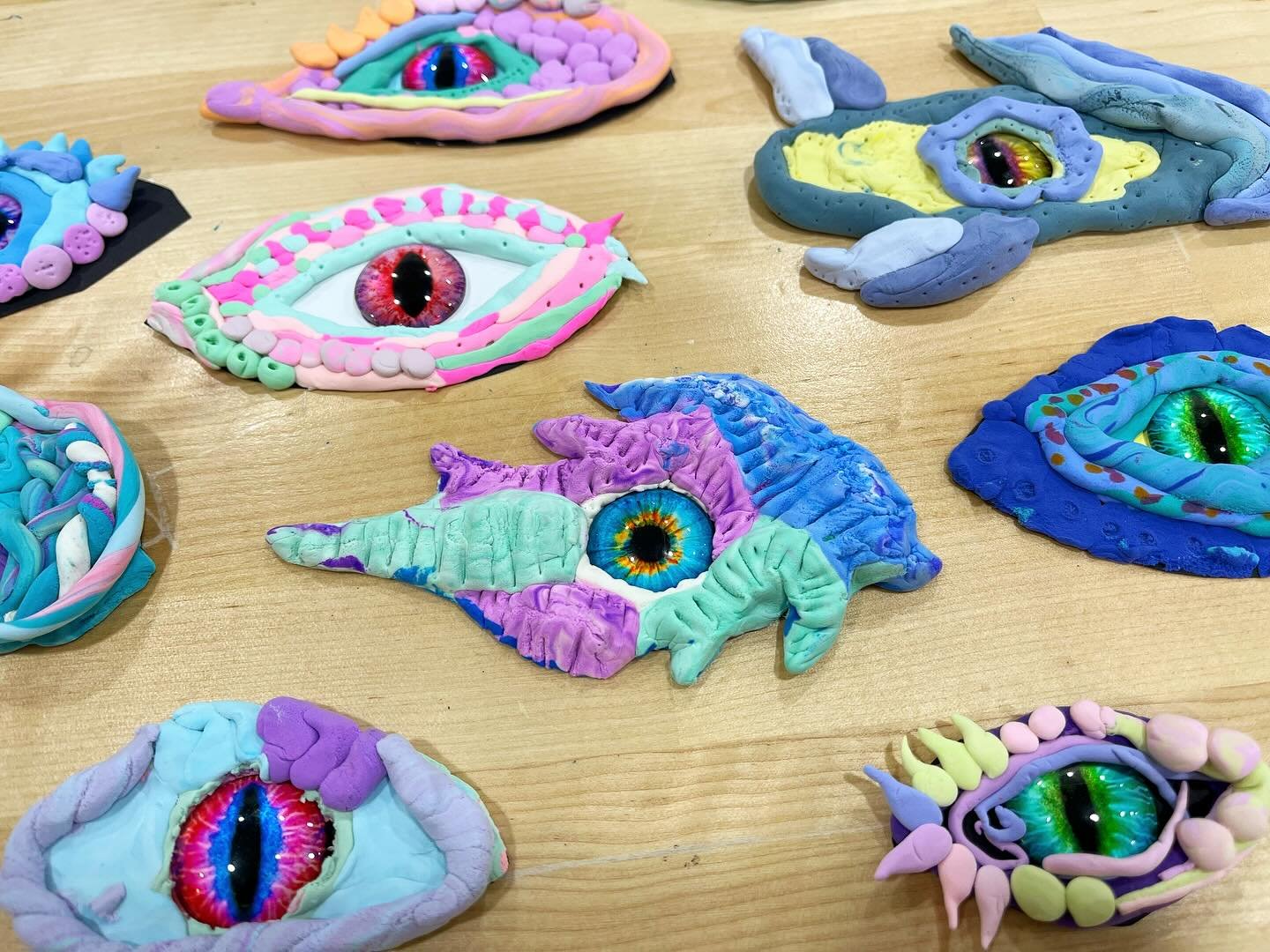 We finally made DRAGON EYES with the flat eye marbles!!! (Order a set online!) Students got to choose between so many different colors when the pack of eye marbles was opened. Students dyed their white air-dry clay different colors with ink, and crea