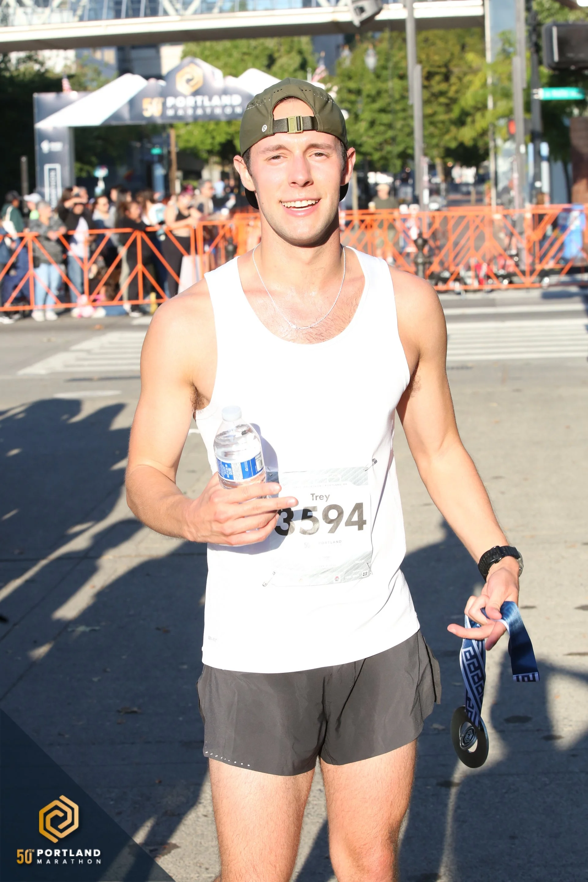 Trey Gullickson poses with his Portland Marathon finisher's medal