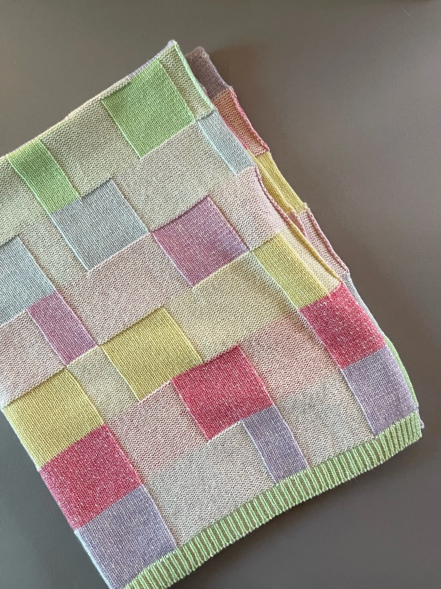 Picture of a plated baby blanket made on knitting machine, using both main and ribber bed