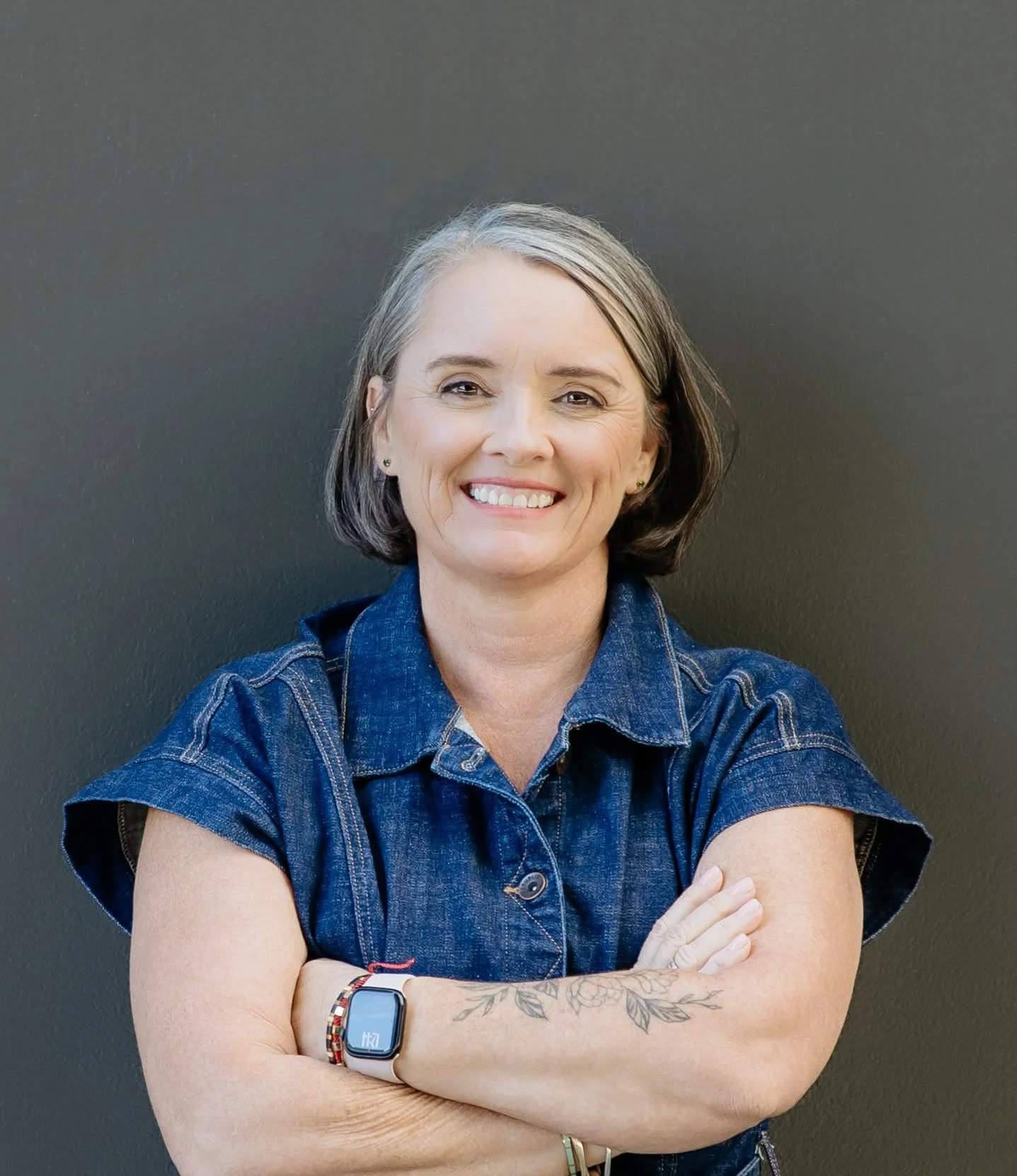 A kiwi business woman is smiling into the camera for her headshot, she has natural makeup that was done by makeup artist naeema in auckland NZ
