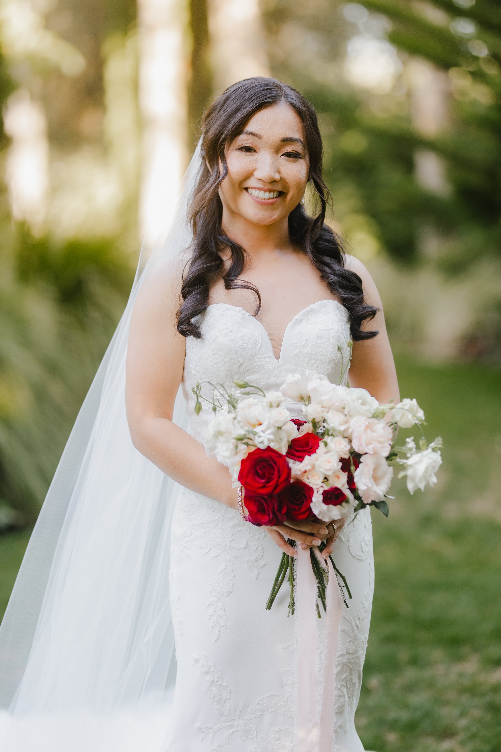 Chinese bride with soft glam bridal makeup and  curled hair for her bridal hairstyle, getting married in Auckland NZ during summer
