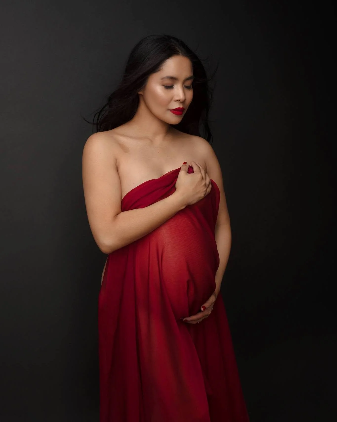 Asian pregnant woman with soft glam makeup posing for a maternity photoshoot in auckland NZ