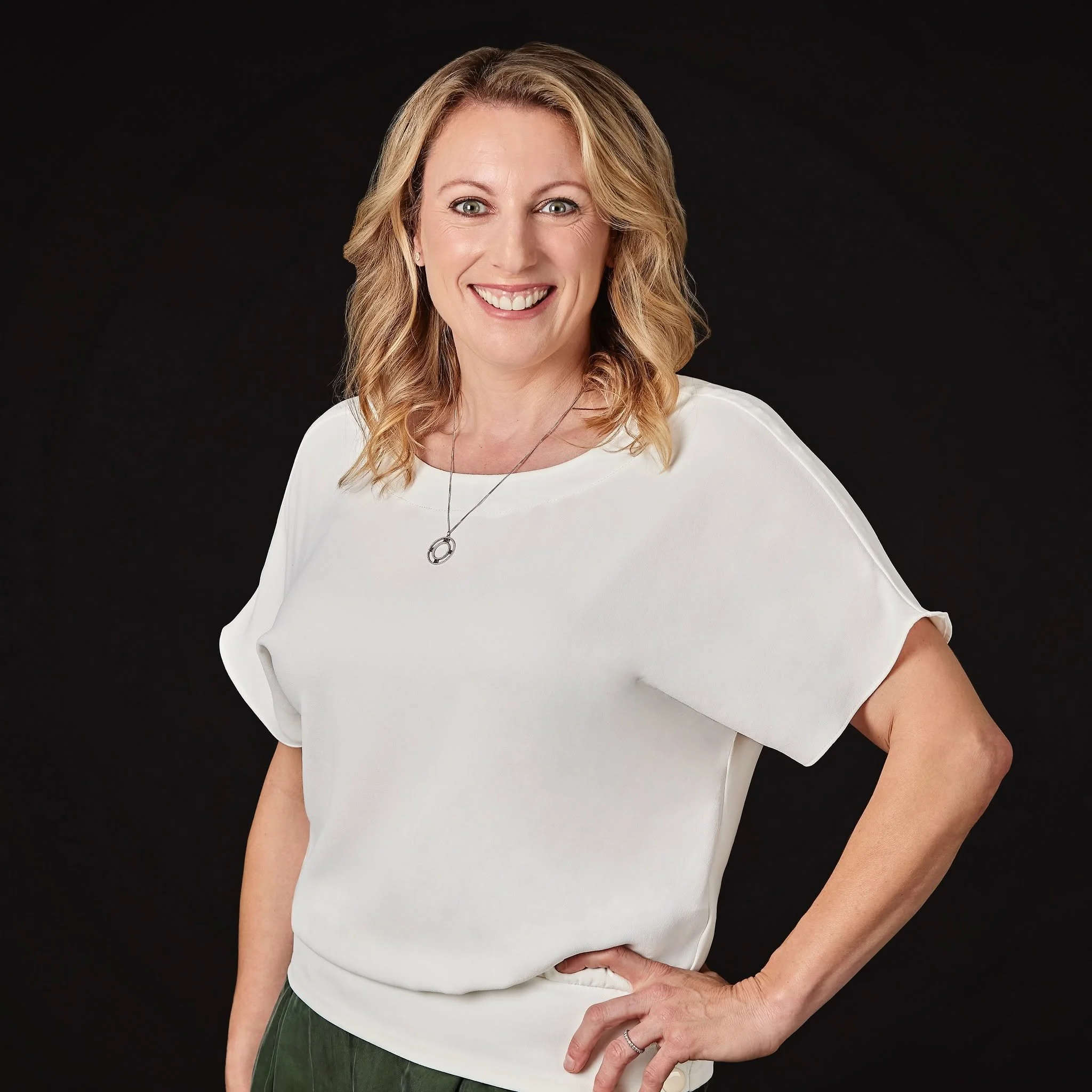 Blonde haired woman in Auckland NZ, makeup artist naeema has given her a natural makeup look and soft waves in her hair for her business branding photos