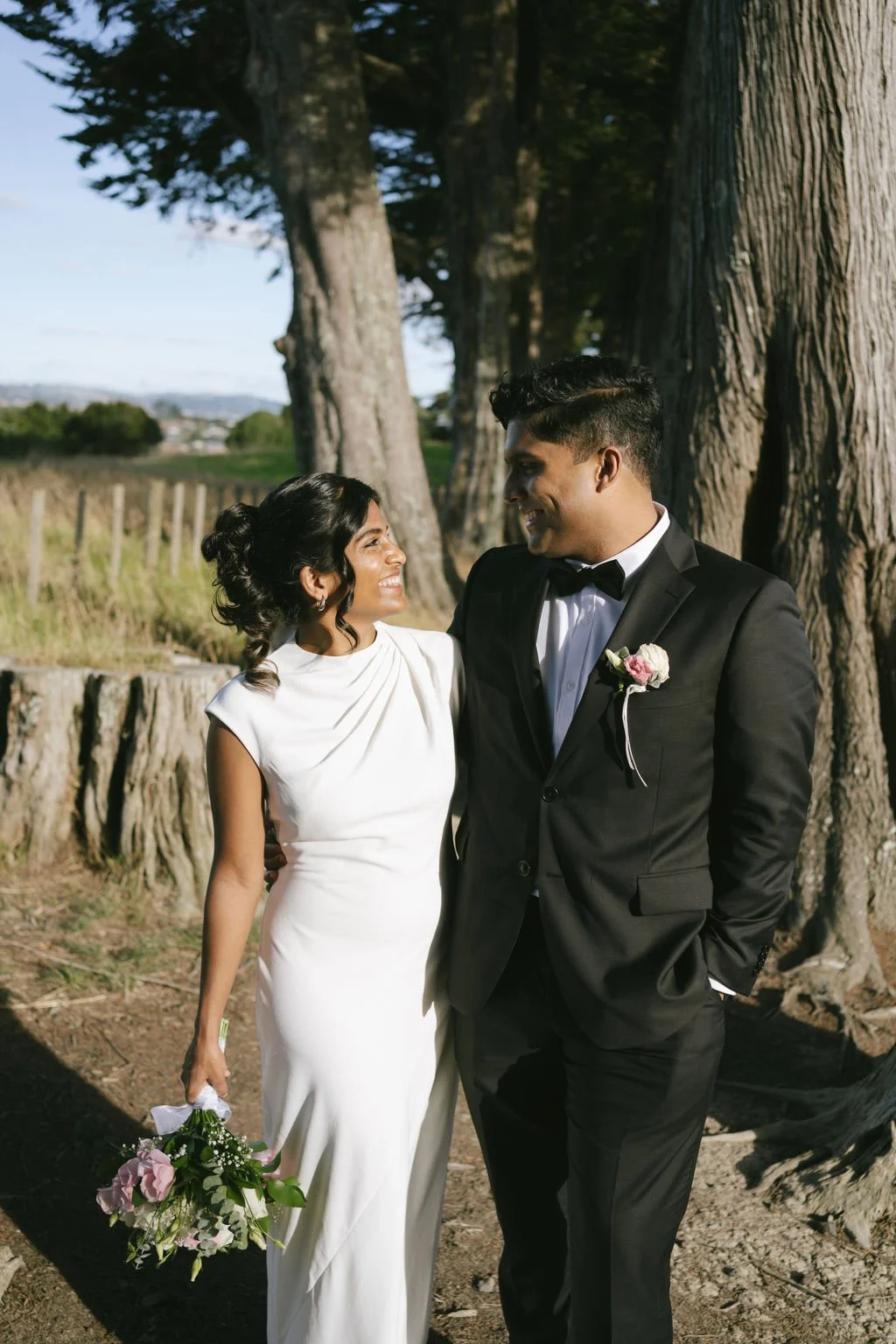 Catholic indian couple having candid photos after their intimate church wedding cedremony in Auckland, NZ