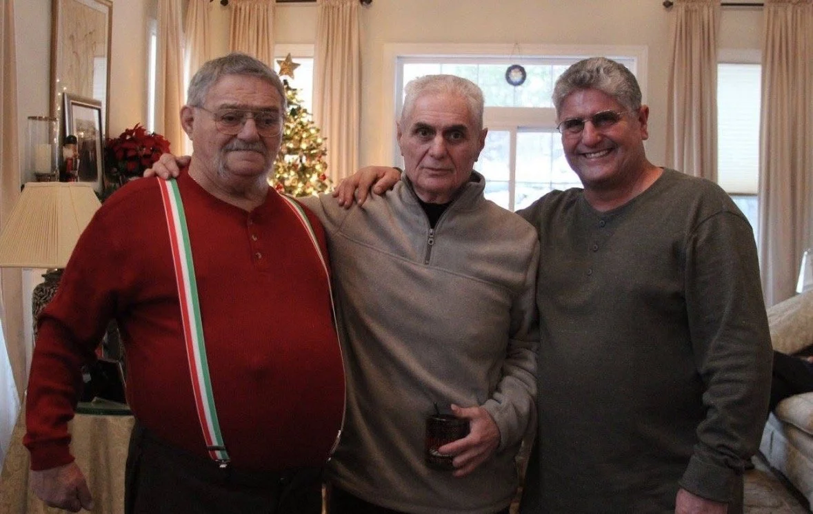 Joseph, John and Anthony Zeolla standing together at a family Christmas gathering.