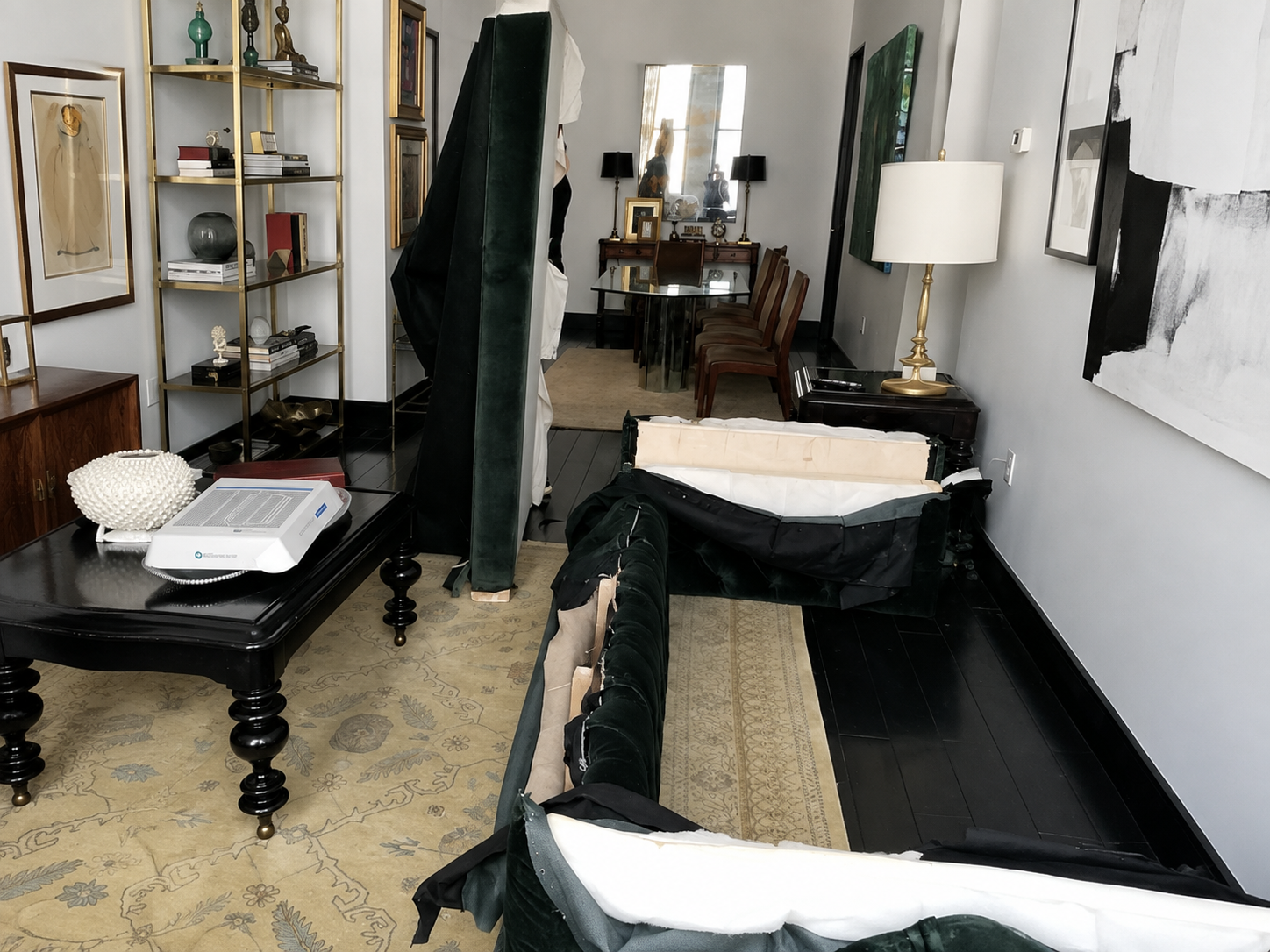 Dark green velvet sofa carefully disassembled to expose its internal structure before move