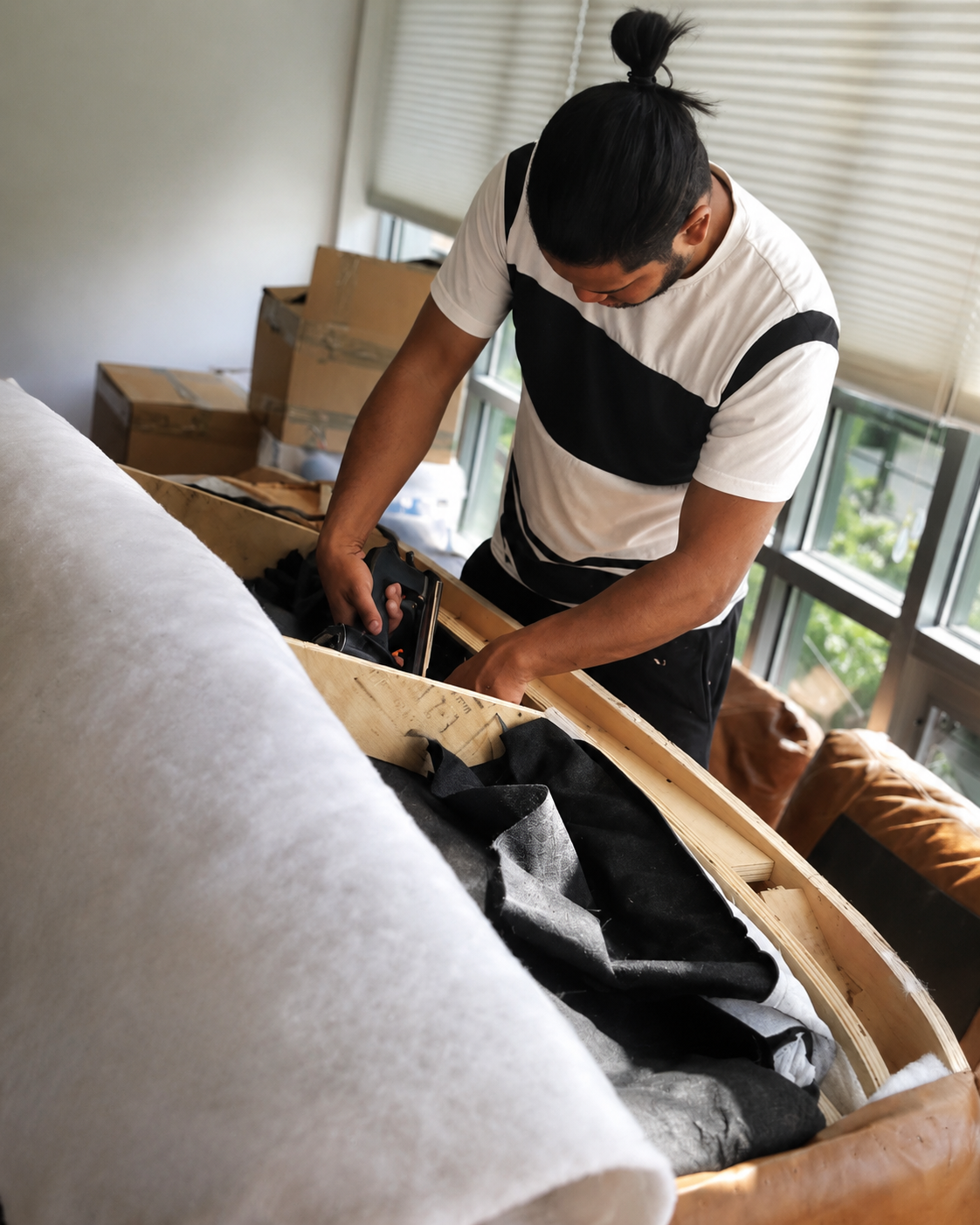 Z Brothers craftsman professionally disassembling upholstered furniture inside a client’s home
