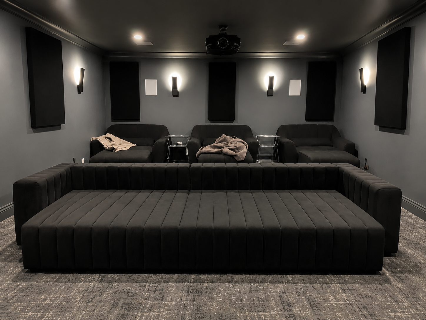 - Black channel-tufted modular seating professionally reassembled inside a finished home theater