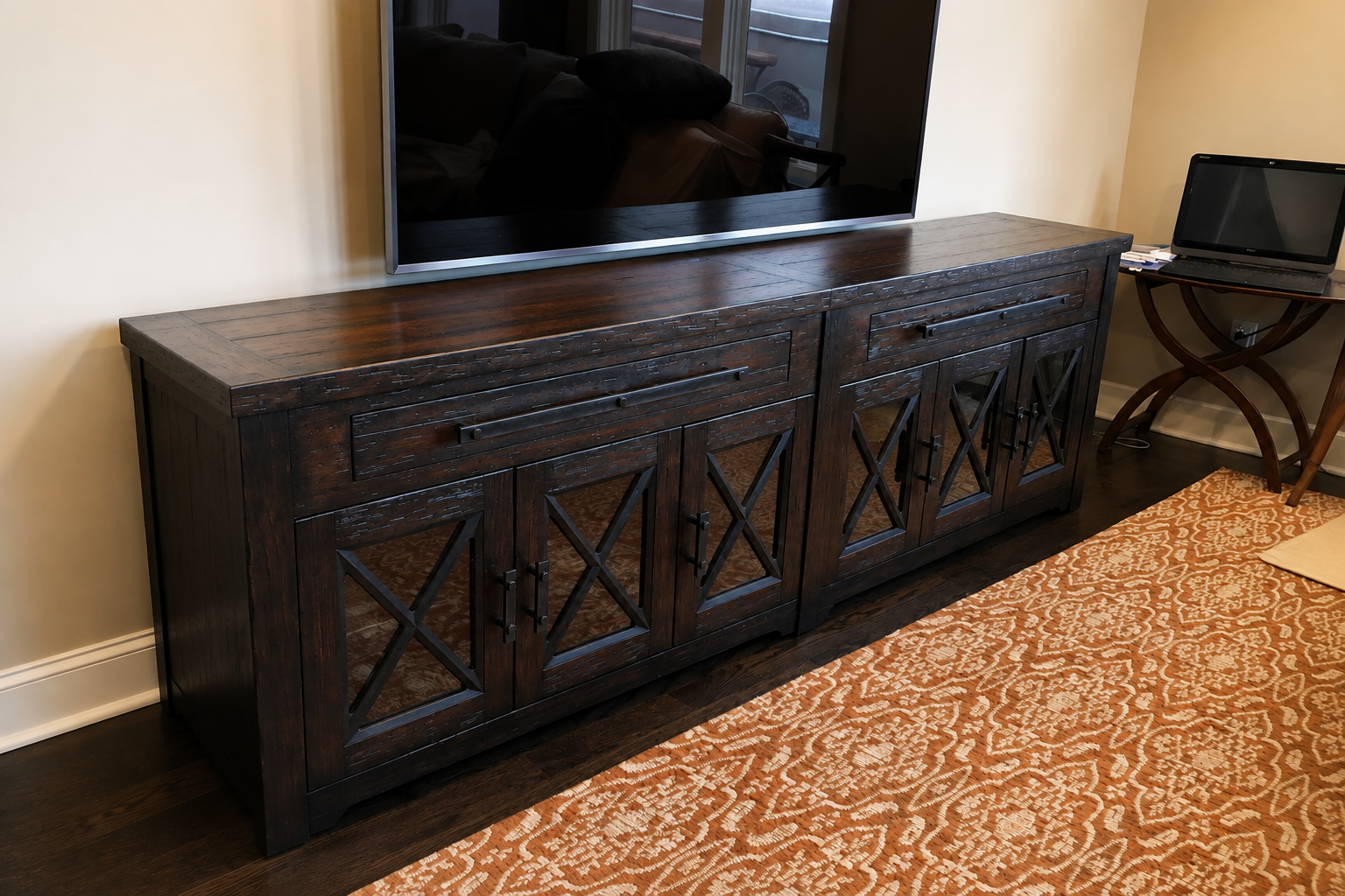 Custom dark wood media console professionally disassembled and reassembled inside a client’s home