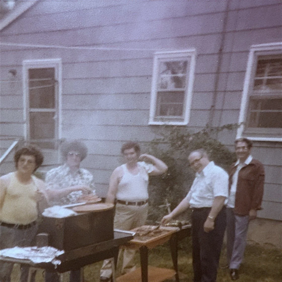 Vintage family photograph of Antonio “Tony” Zeolla with his sons and relatives at a backyard gathering.