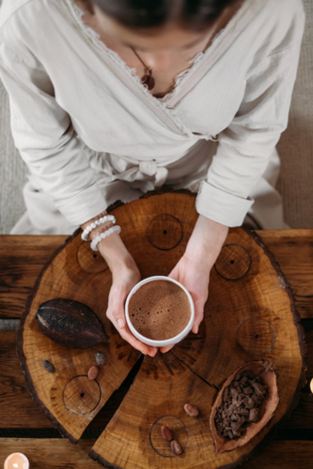 Woman holding a cup of ceremonial cacao