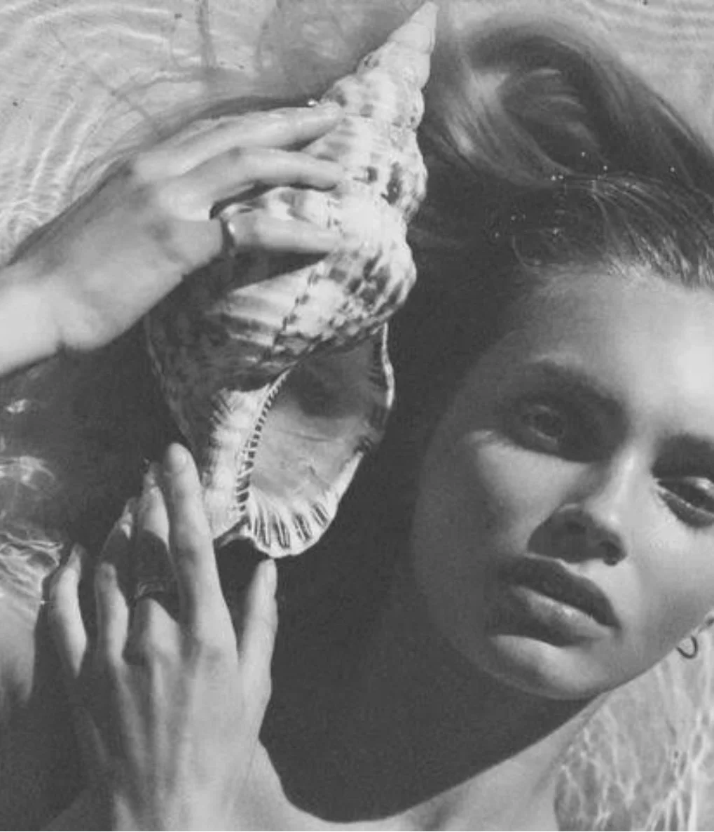 Woman holding a seashell in her hands