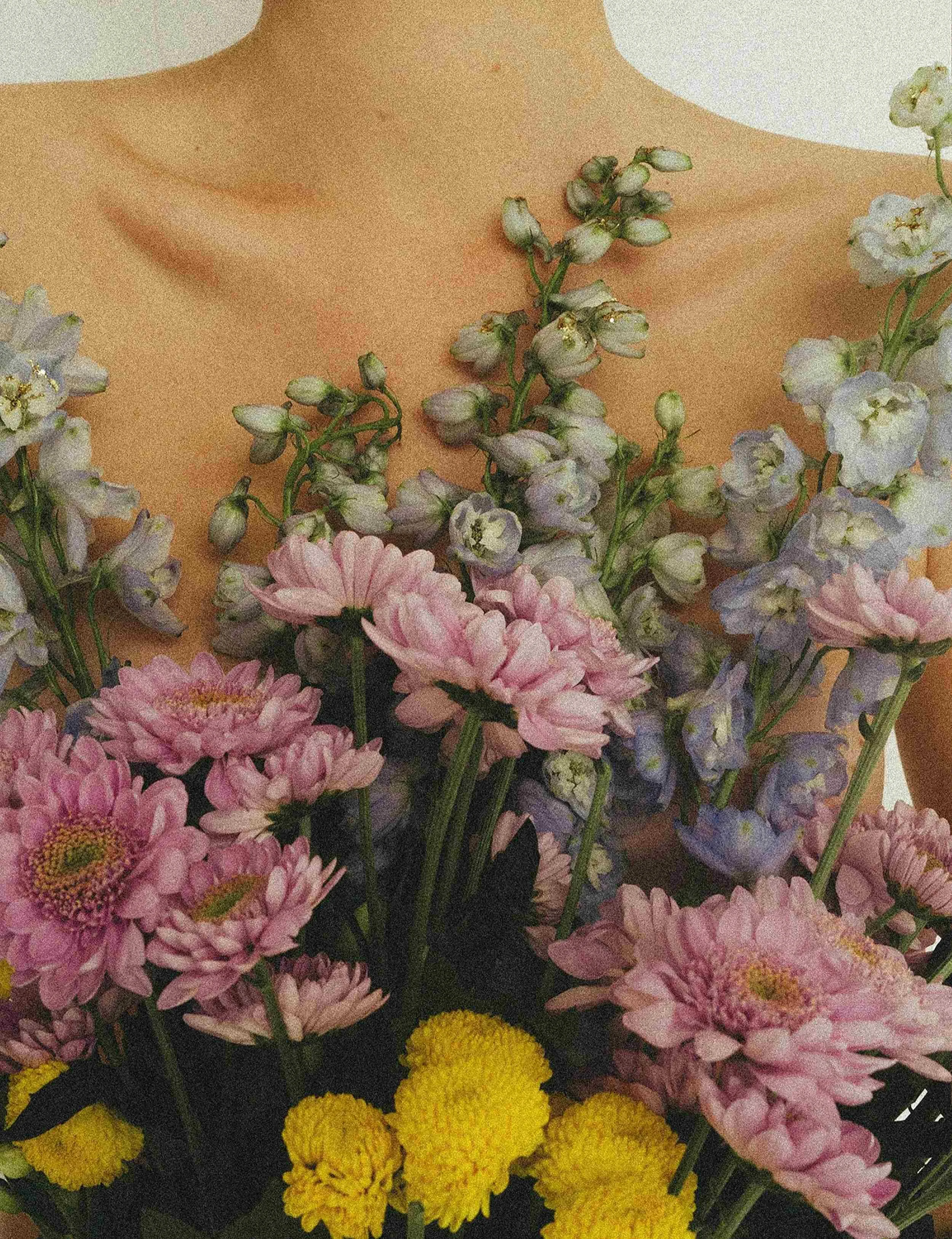 Woman holding flowers to her chest, astrology mentorship at Luna Sanctum