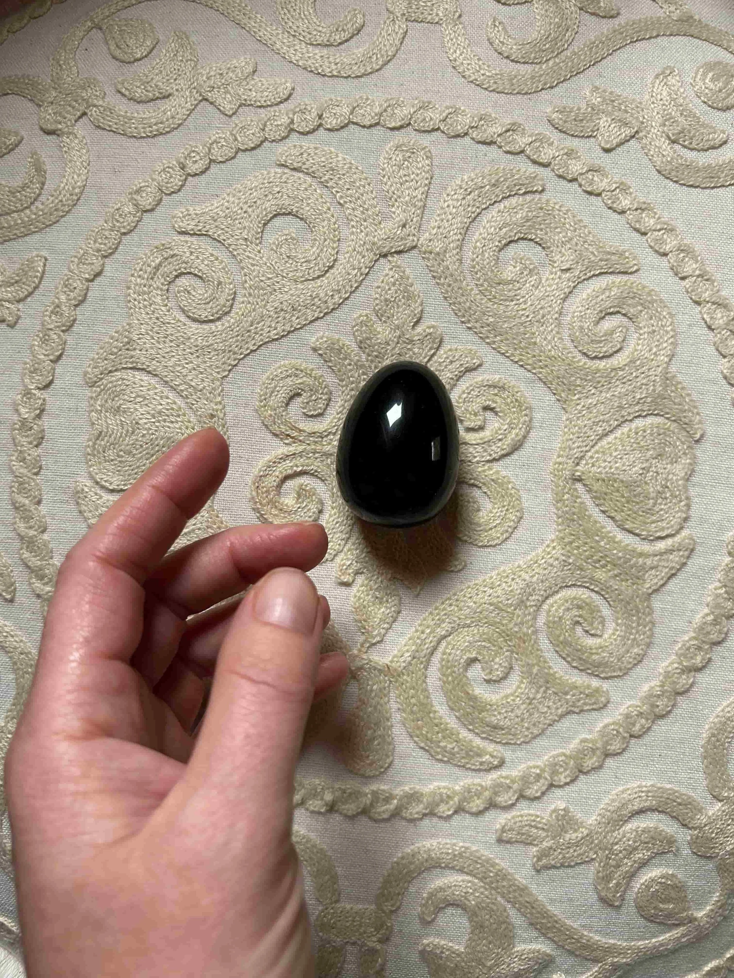 Polished black obsidian yoni egg