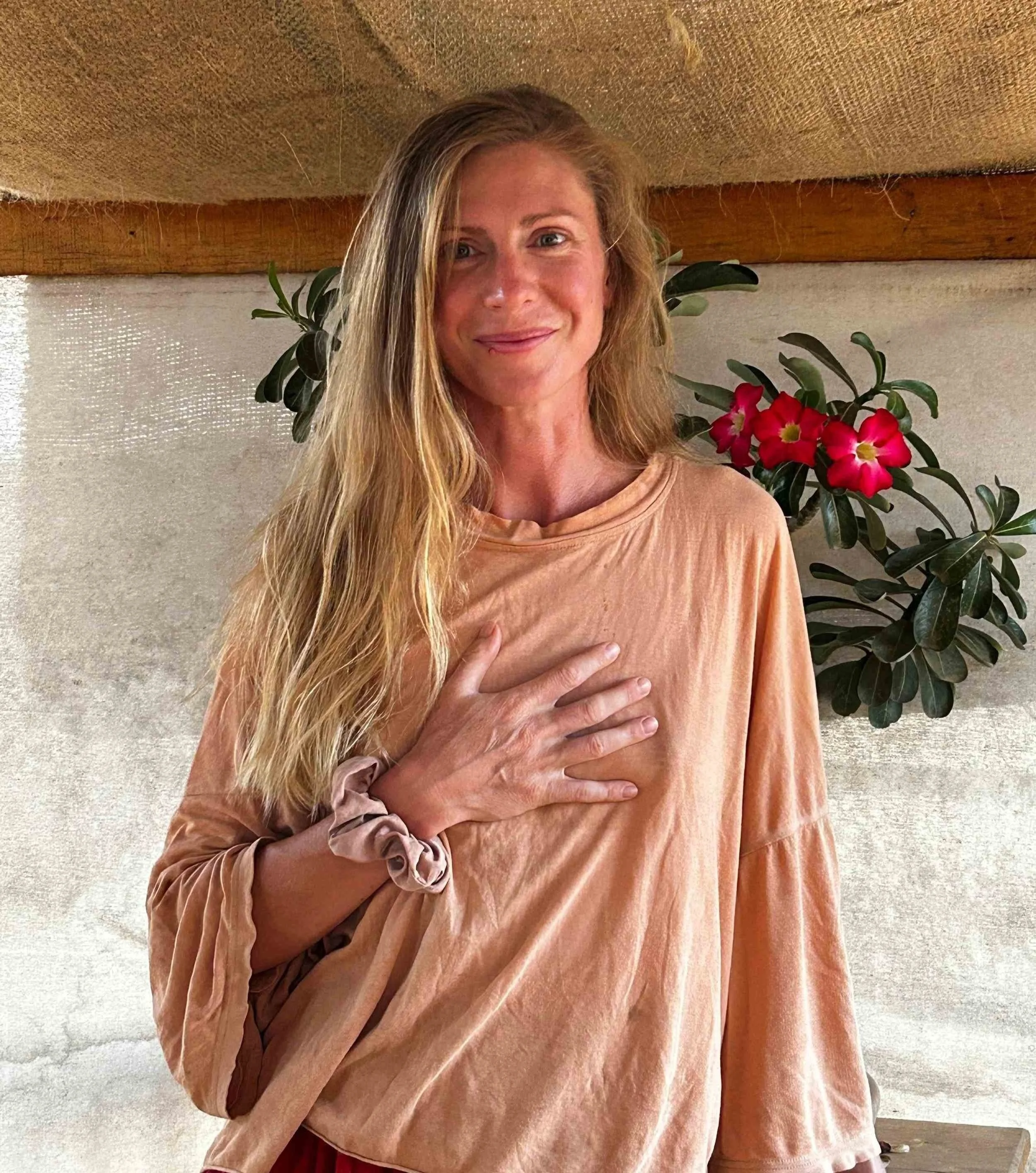Woman with her hand resting on her heart.