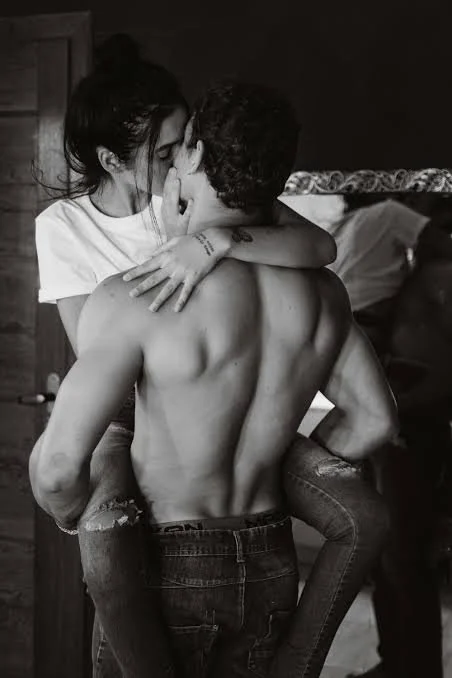 Couple holding each other close, kissing