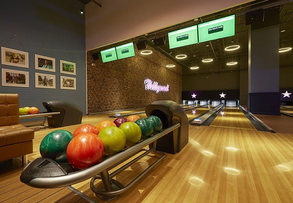 Bowling balls lined up in a rack at Hollywood bowl