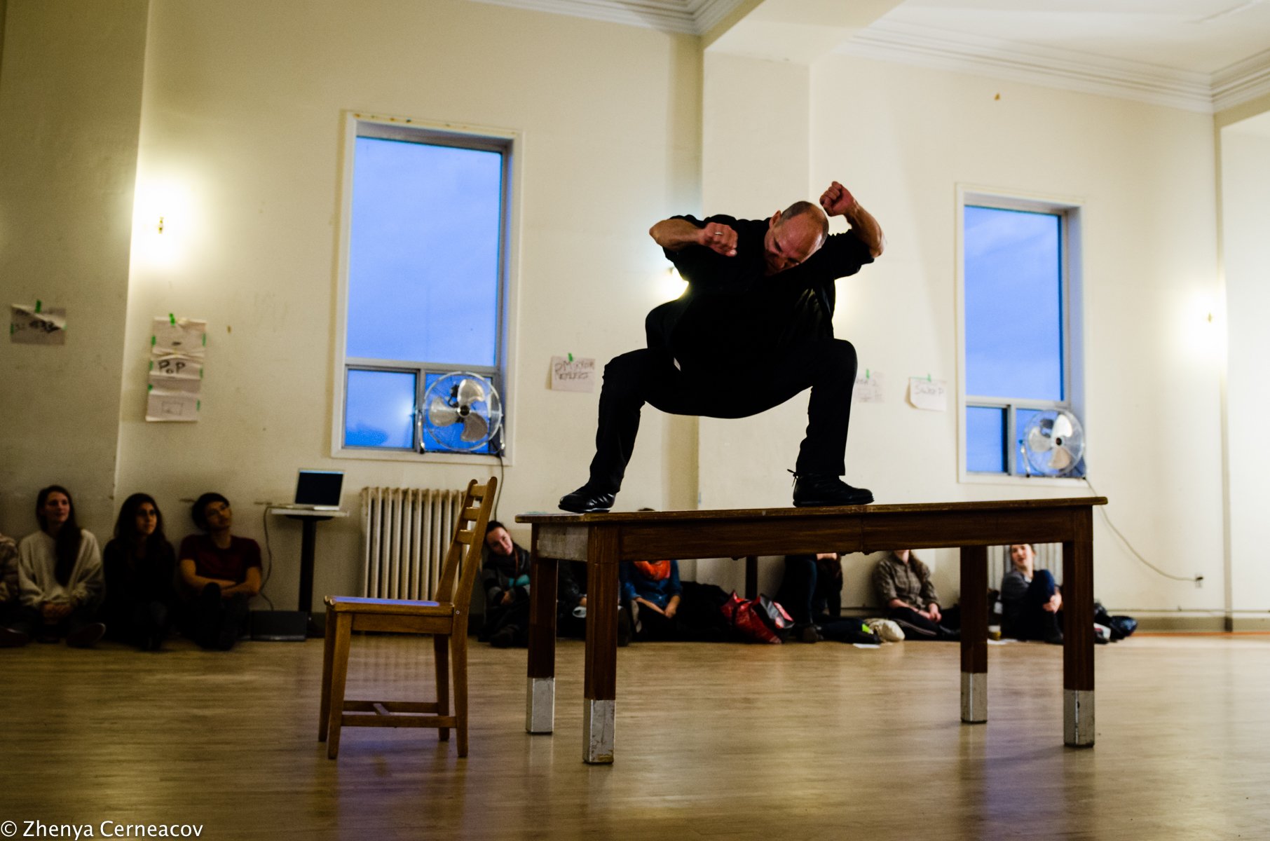 Allen crouches on top of a table.