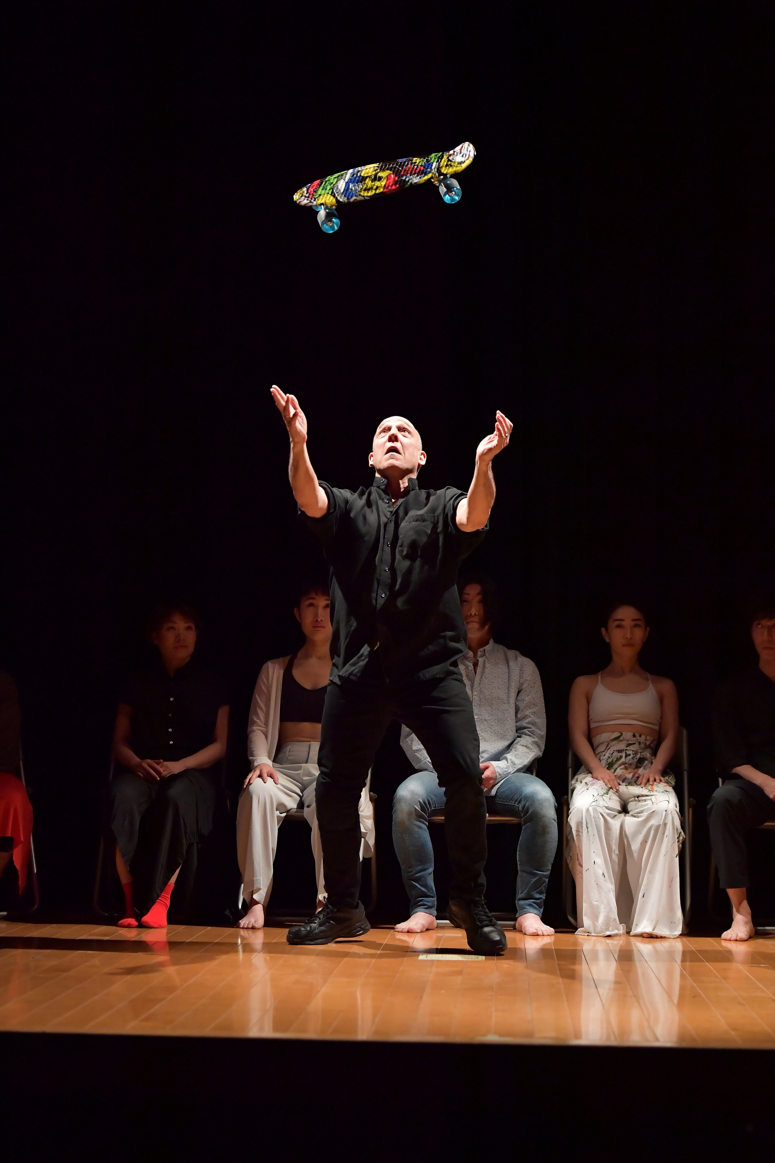 Allen Kaeja throws a skateboard into the air.