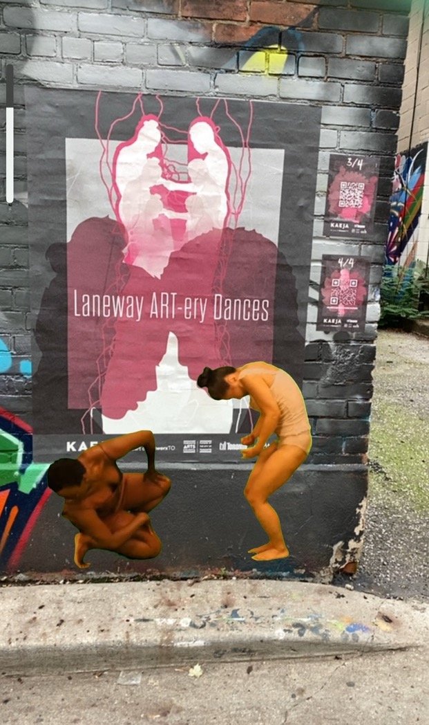 Two dancers appear in front of a wall in Augmented Reality.