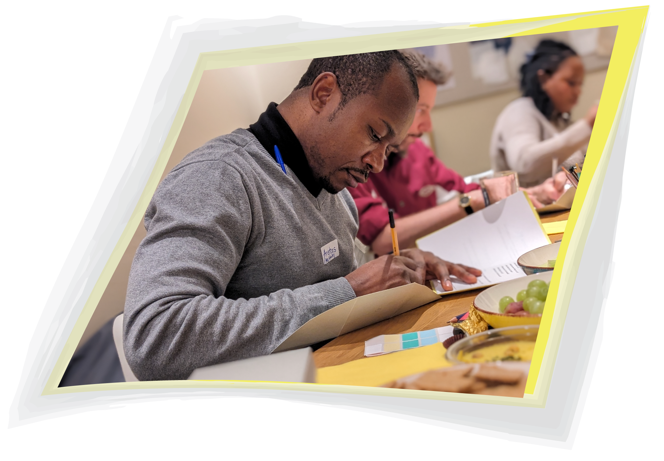 From a Veronica Louis Workshop: Photo of a man focussed on writing in his workshop workbook.