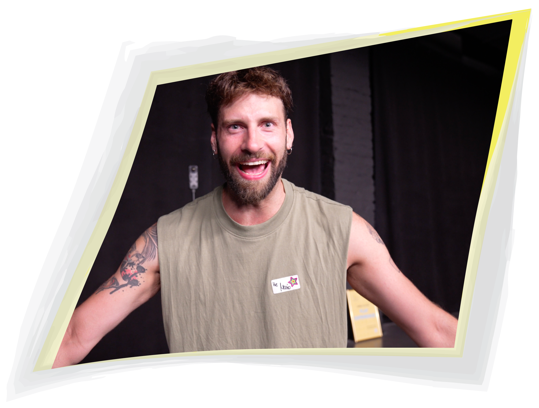 Grinning man wearing a hand-drawn name tag