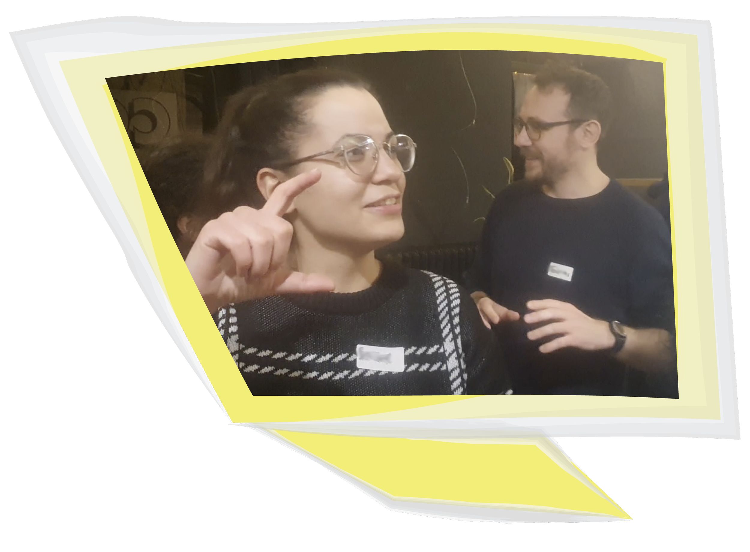 A woman wearing glasses, smiling, and using body language