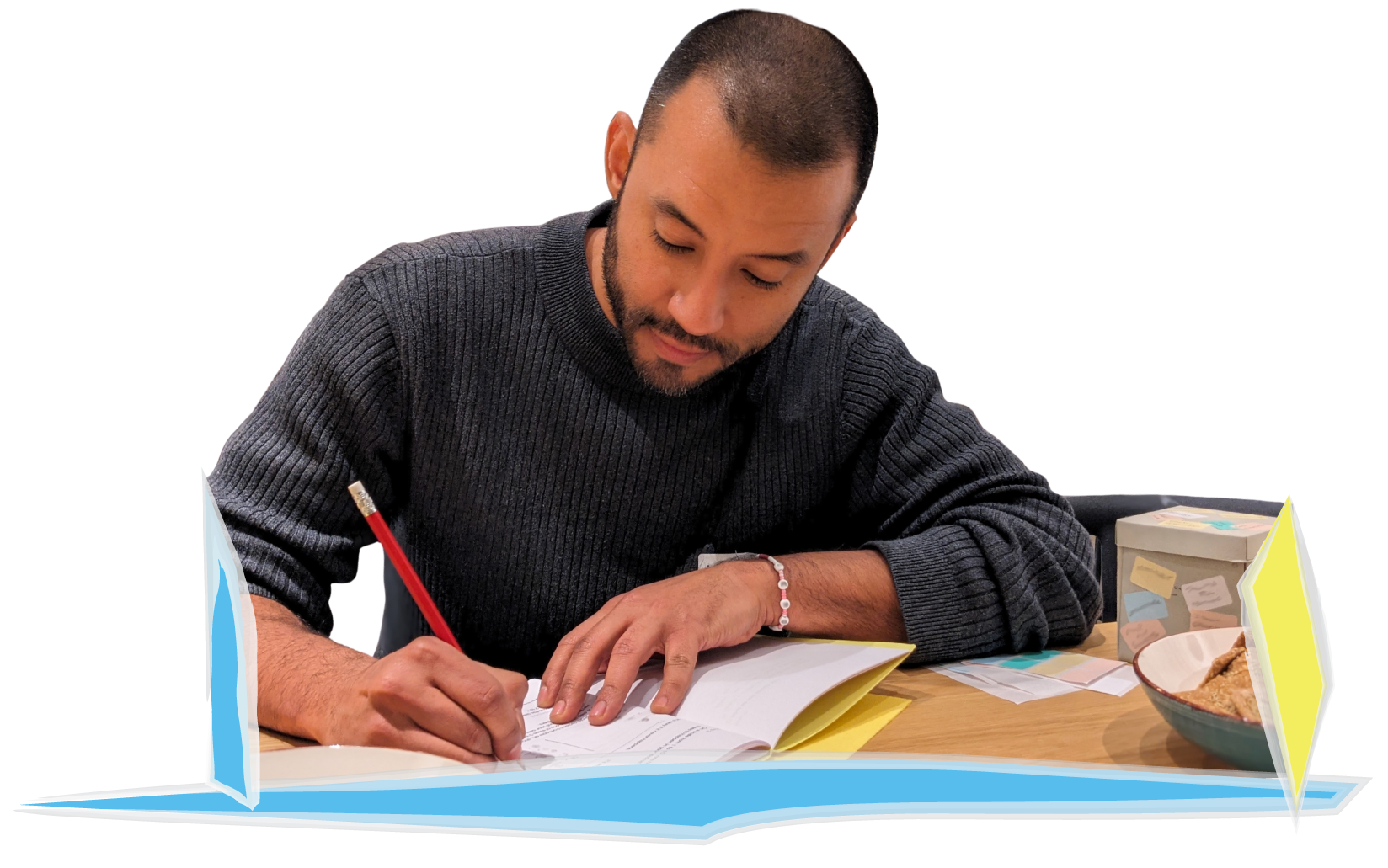From a Veronica Louis Workshop: Photo of a man focussed on writing in his workshop workbook.