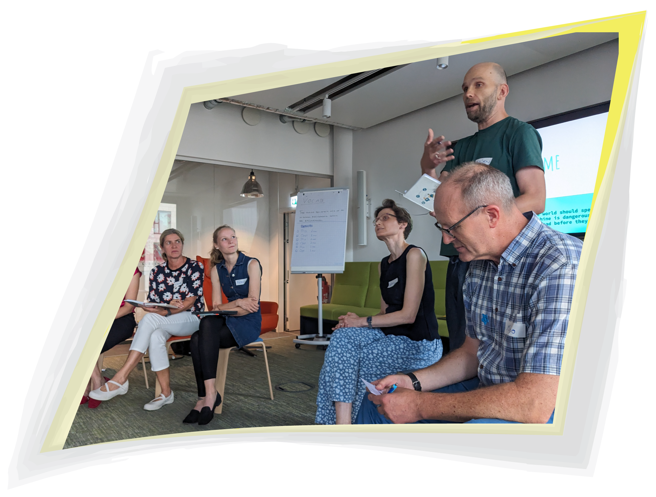 From a Veronica Louis Workshop: Photo of a handful of people listening to a man as he presents an exercise.