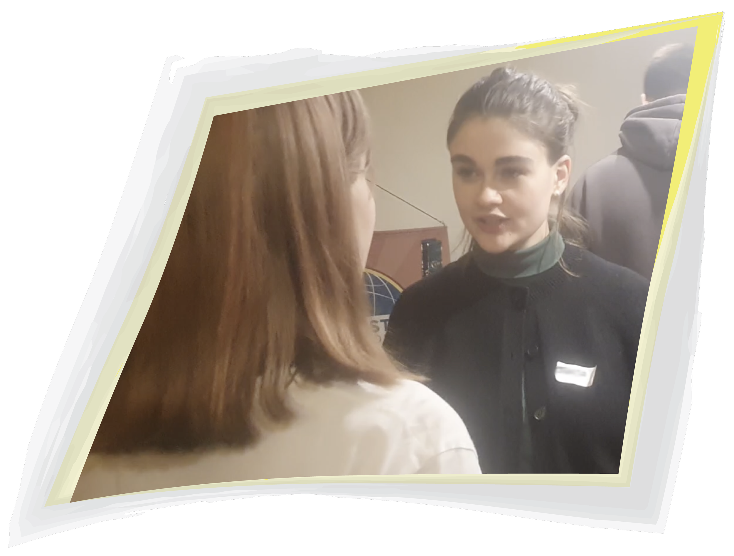 Two young women facing each other and talking