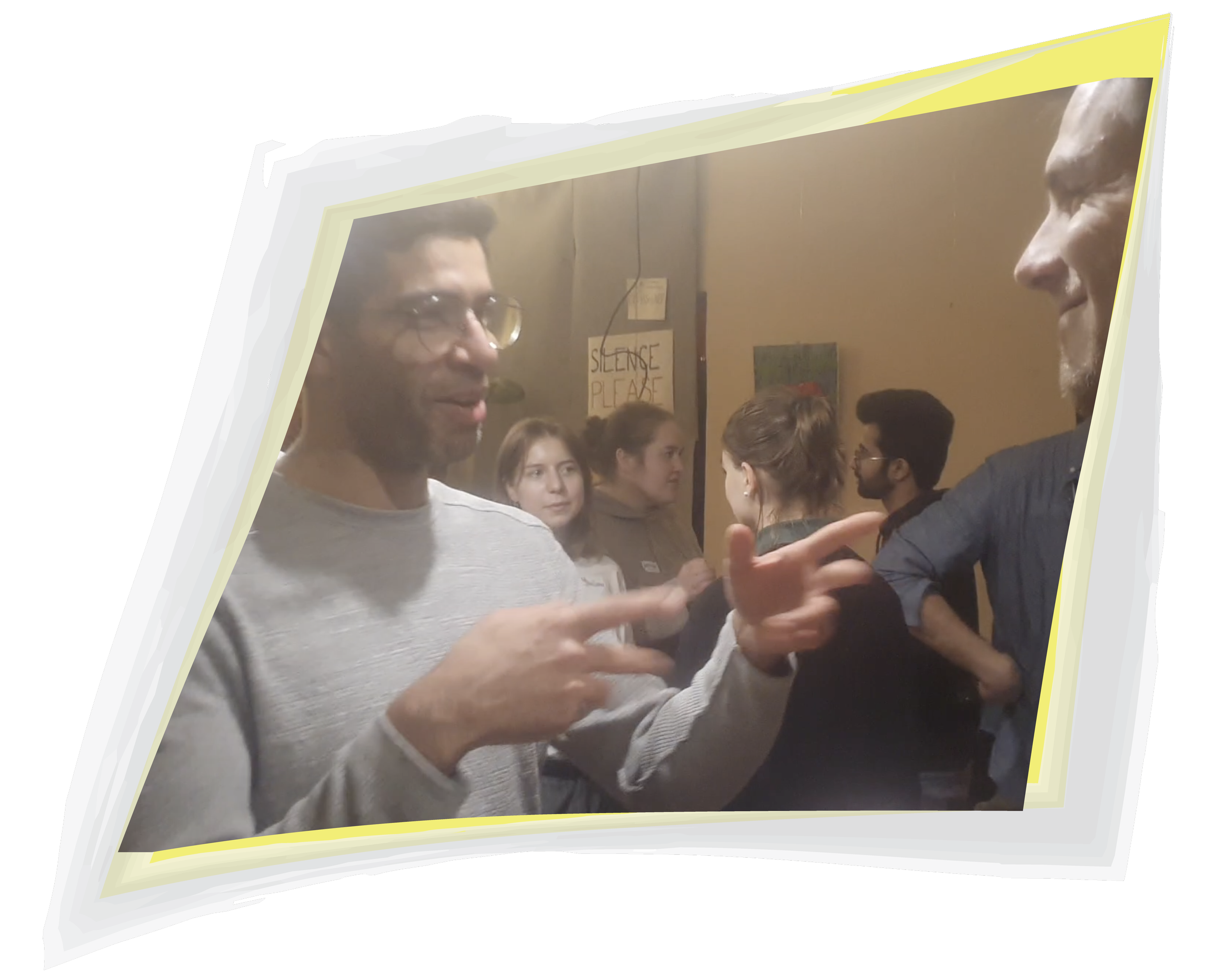 Two men energetically, smiling, and talking with each other using body language