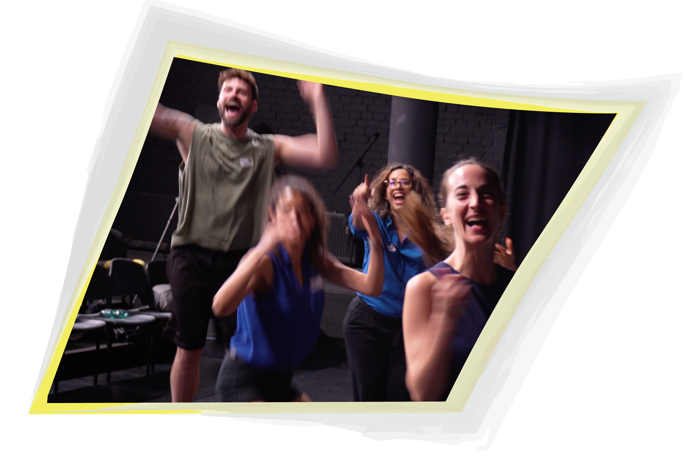 Four people laughing with arms raised during a group game