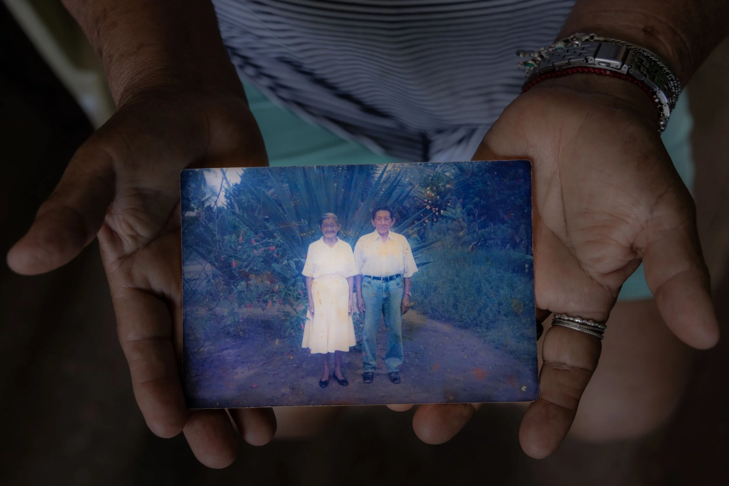  Cristína holding a photo of her family’s time in the church-led indigenous residential school. 