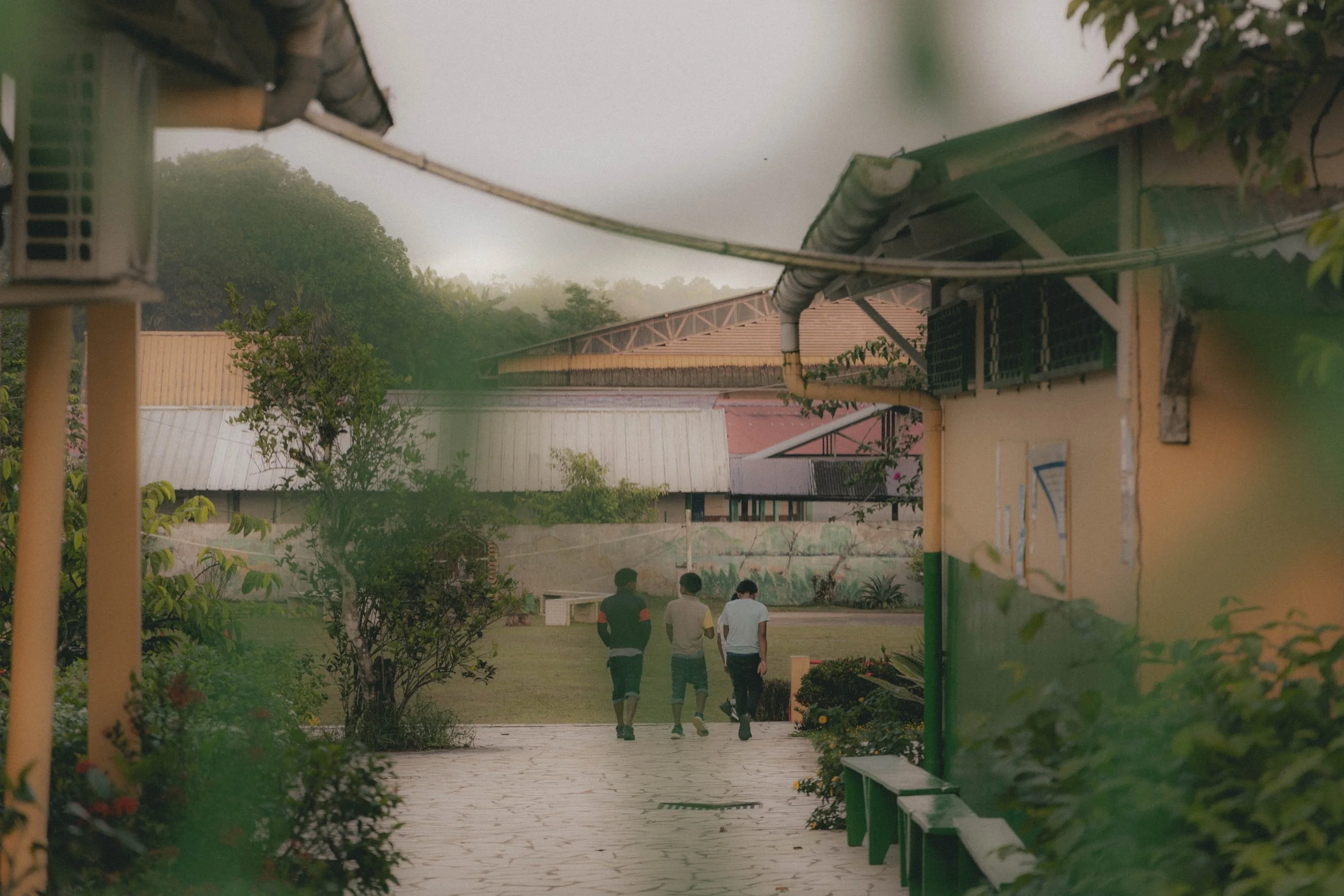  Three children walking inside the residential school.    Indigenous children of these ‘Homes’ are known for running away. Often in an attempt to go back to their families in vain.  I talked to a nun, sister Bénédicte, who was fairly transparent of t