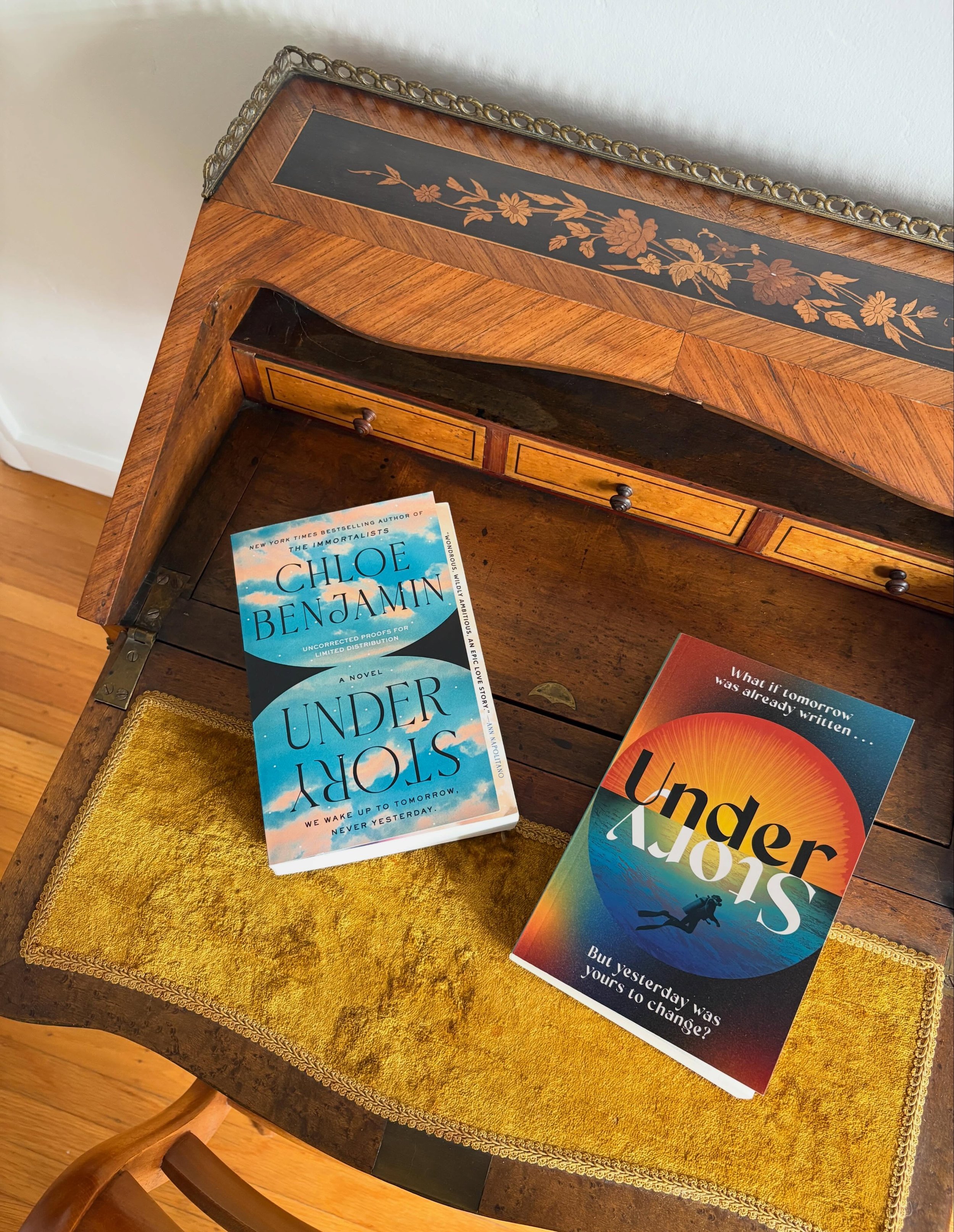 A tale of two covers. 🩵🧡
.
U.S. #UnderStory on the left (@putnambooks // @penguinrandomhouse), U.K. on the right (@tinder_press // @headlinebooks)! 

I&rsquo;m always fascinated by how different countries approach cover art, and I was blown away by