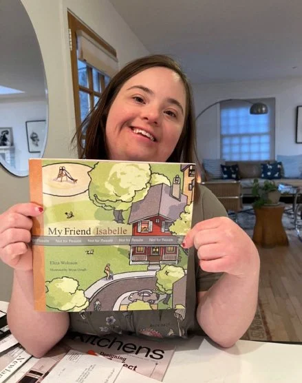 Isabelle holding a draft copy of the book in paperback