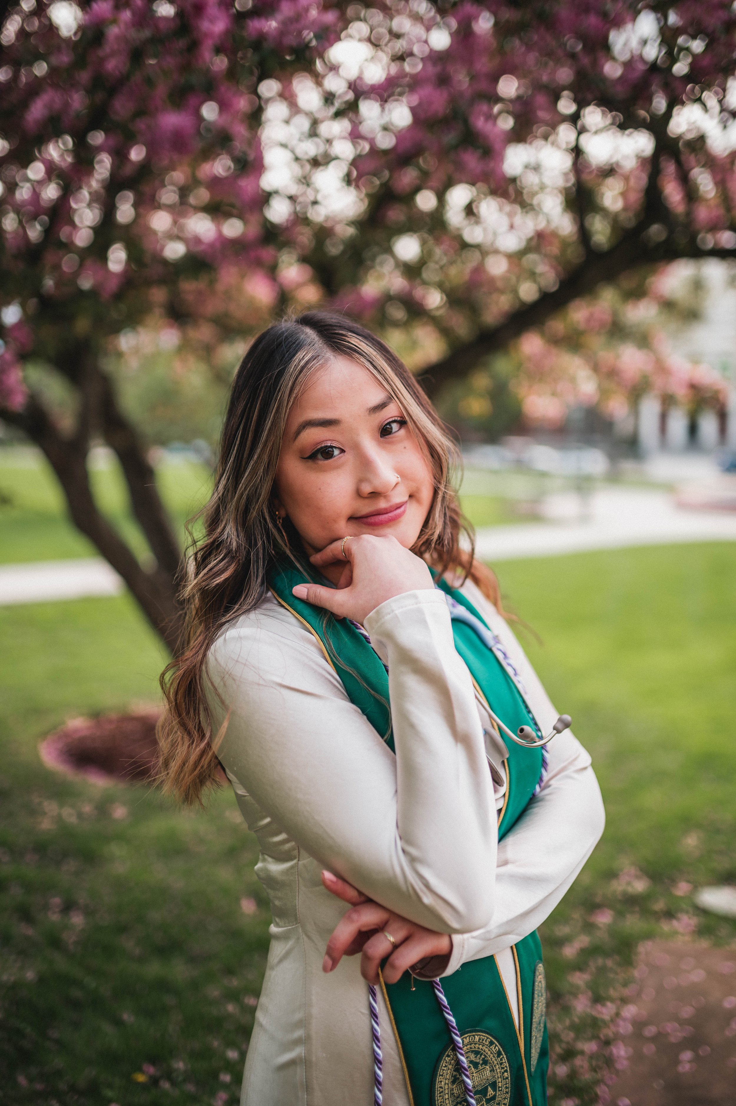 A graduate from the University of Vermont posing in Spring