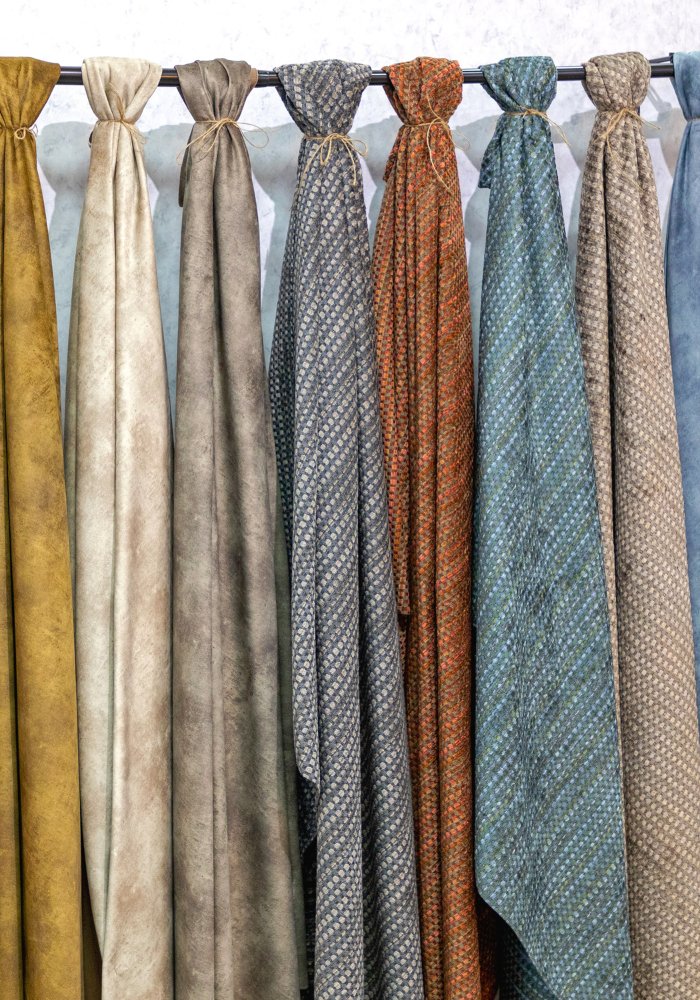 fabric in assorted colors tied around a rod to display luxury textiles that elevate your home.png