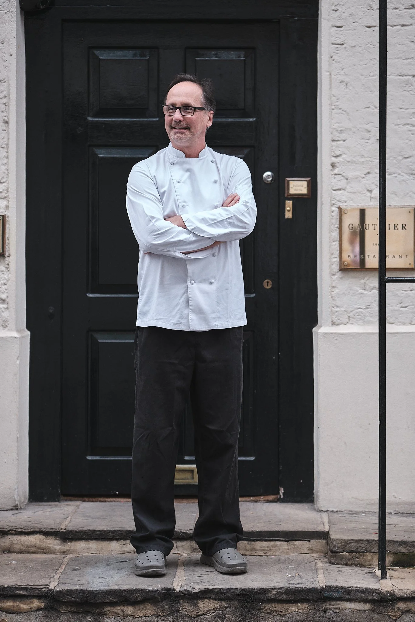 Chef Alexis Gauthier poses for a portrait in front of Gauthier Soho, his restaurant located in a London Soho townhouse. London, England, UK, 2024. Nathalie Merle / We Animals