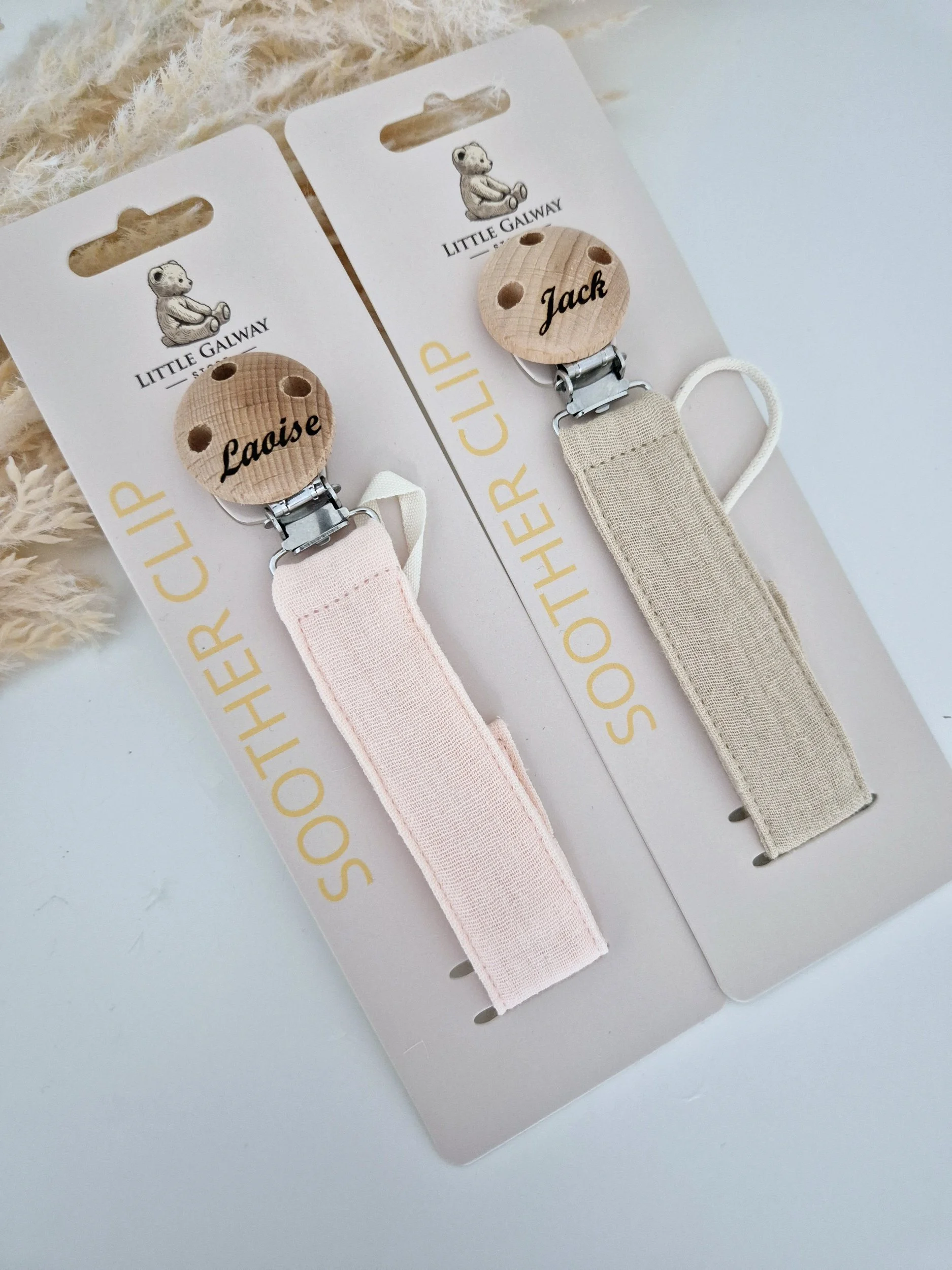 natural linen soother clip collection features a peachy pink linen soother clip and a Natural flax linen soother clip.