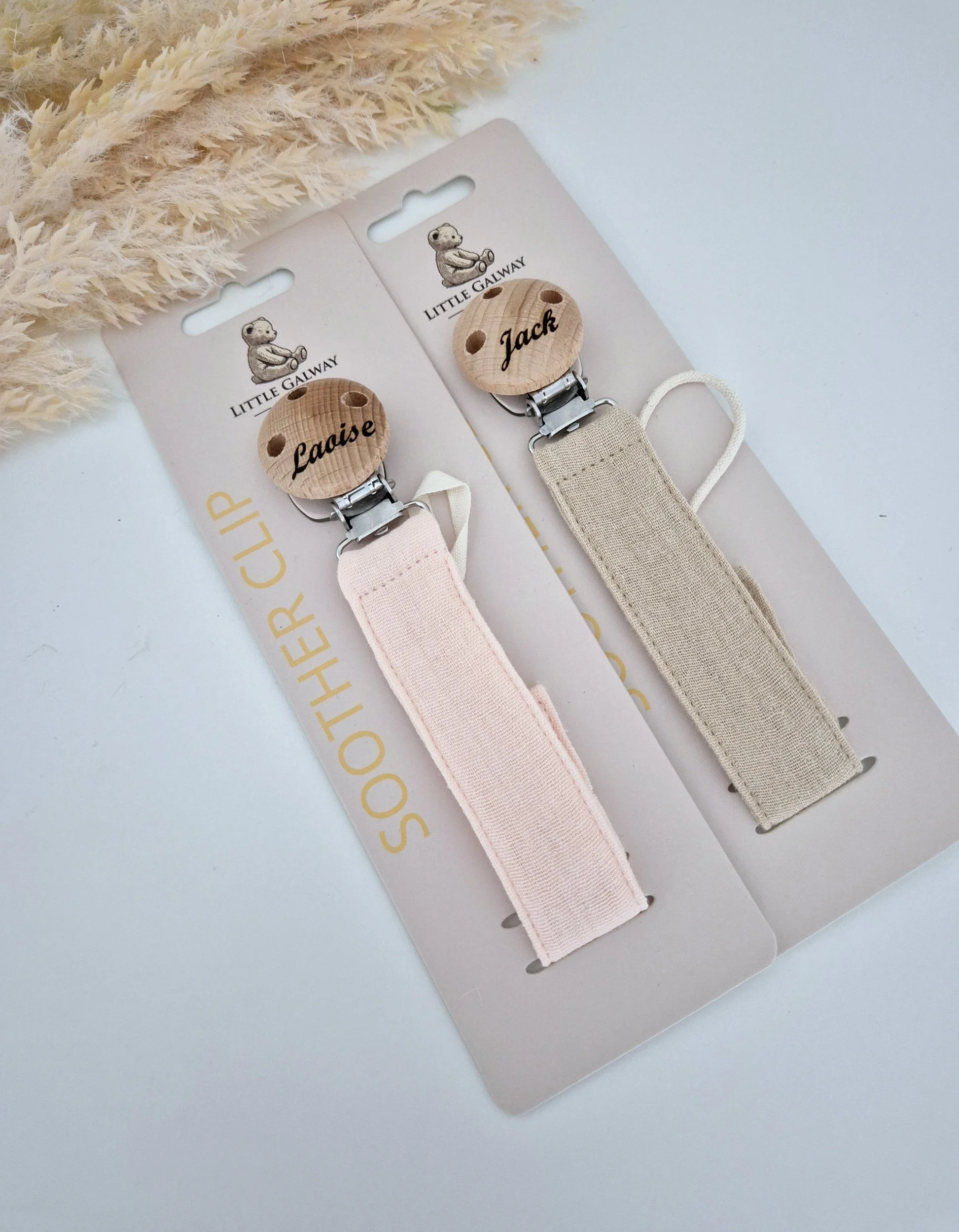 natural linen soother clip collection features a peachy pink linen soother clip and a Natural flax linen soother clip.