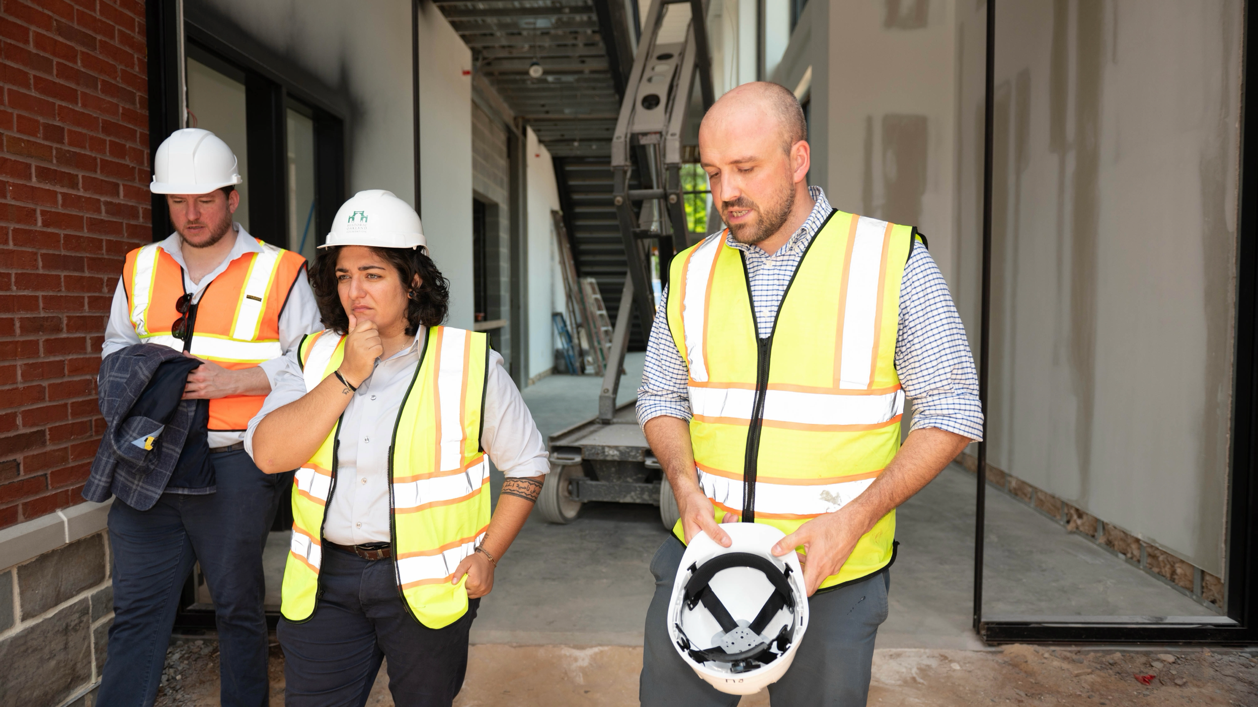 council member Liliana Bahktiari walking with two men at a construction site, all wearing site vest and hardhats