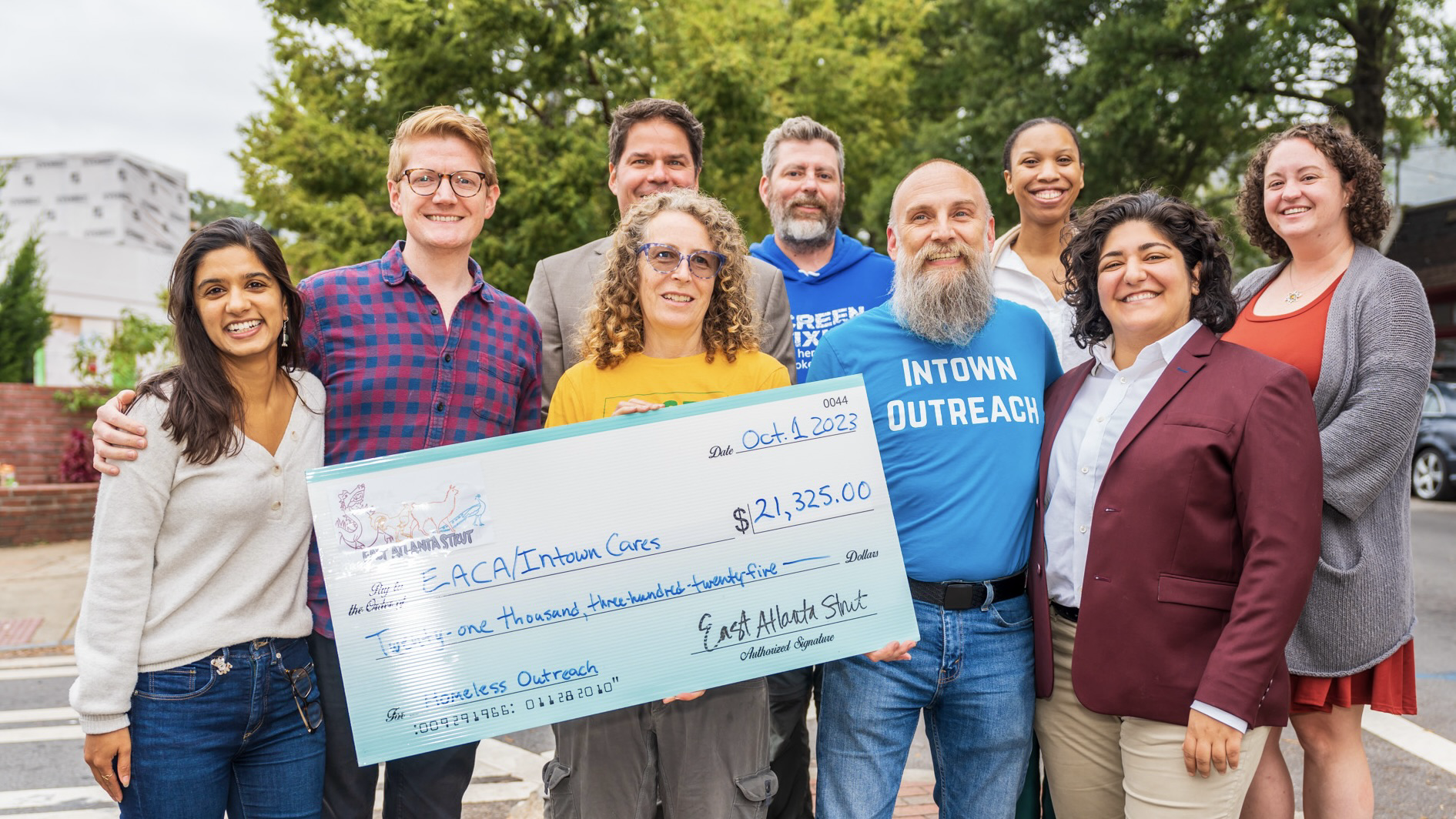 Liliana Bahktiari and a group posing for a picture with a signed check donation
