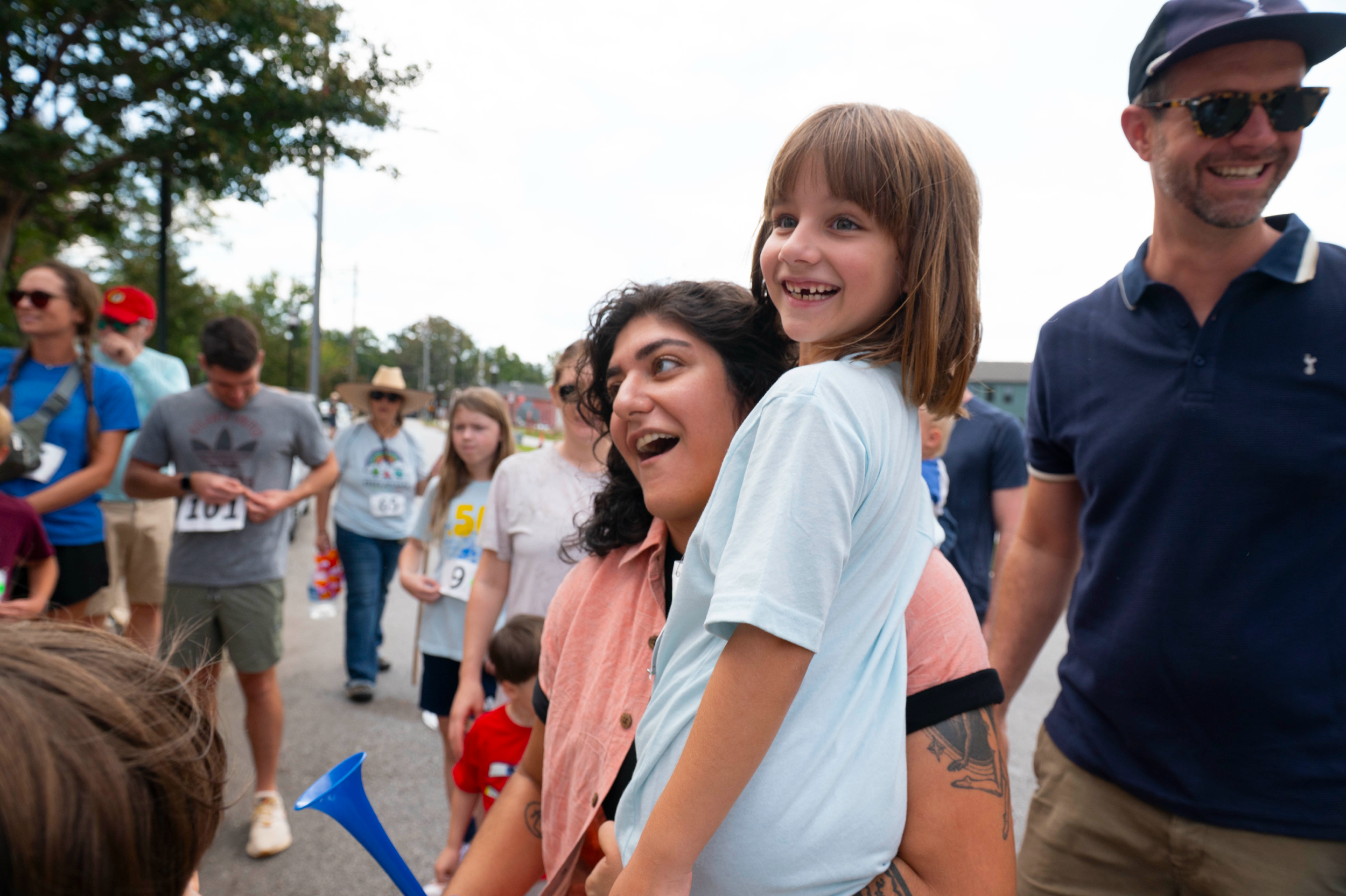 council member Liliana Bahktiari smiling at an event carrying a child
